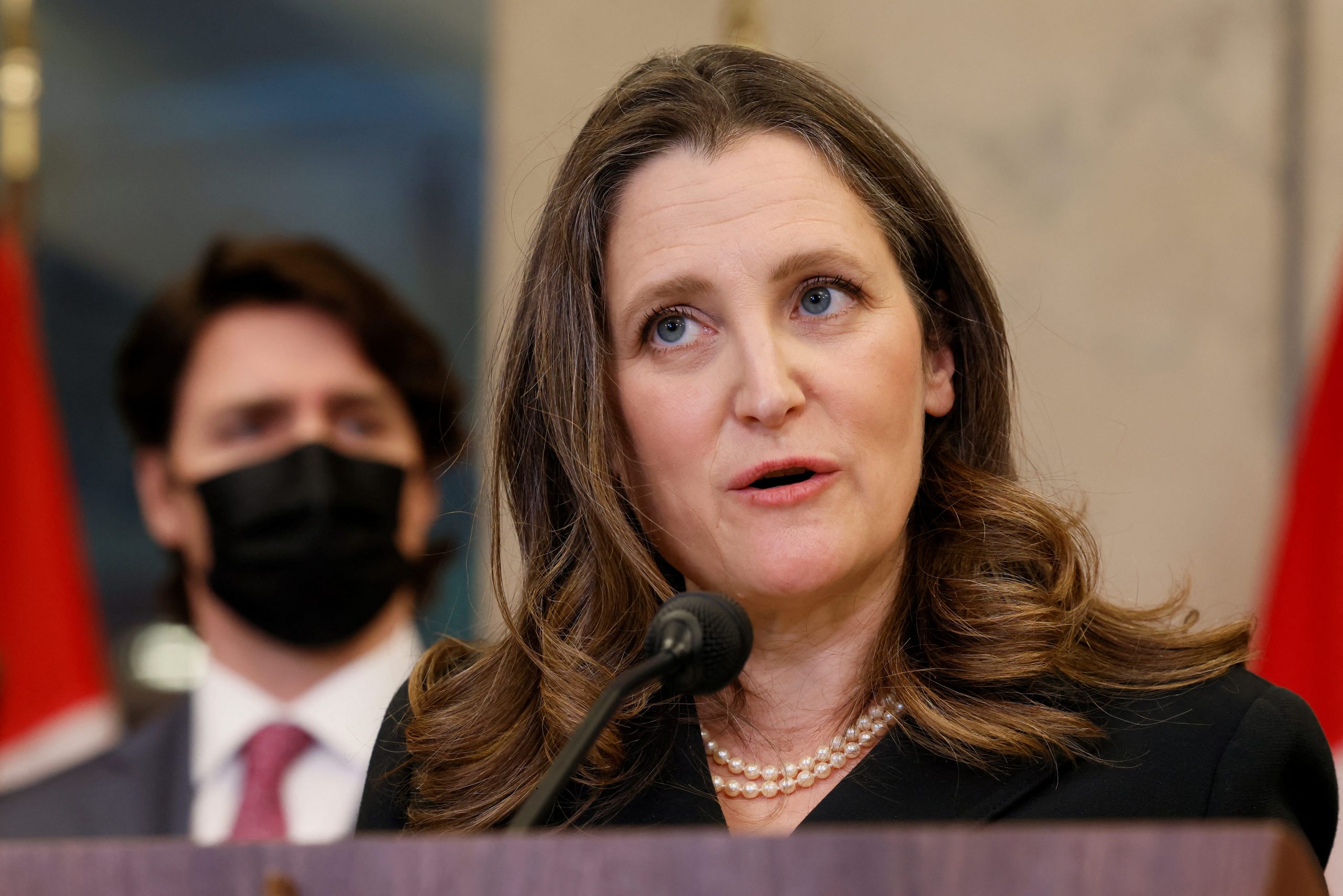 Deputy Prime Minister Chrystia Freeland speaks at a press conference, with Prime Minister Justin Trudeau in the background