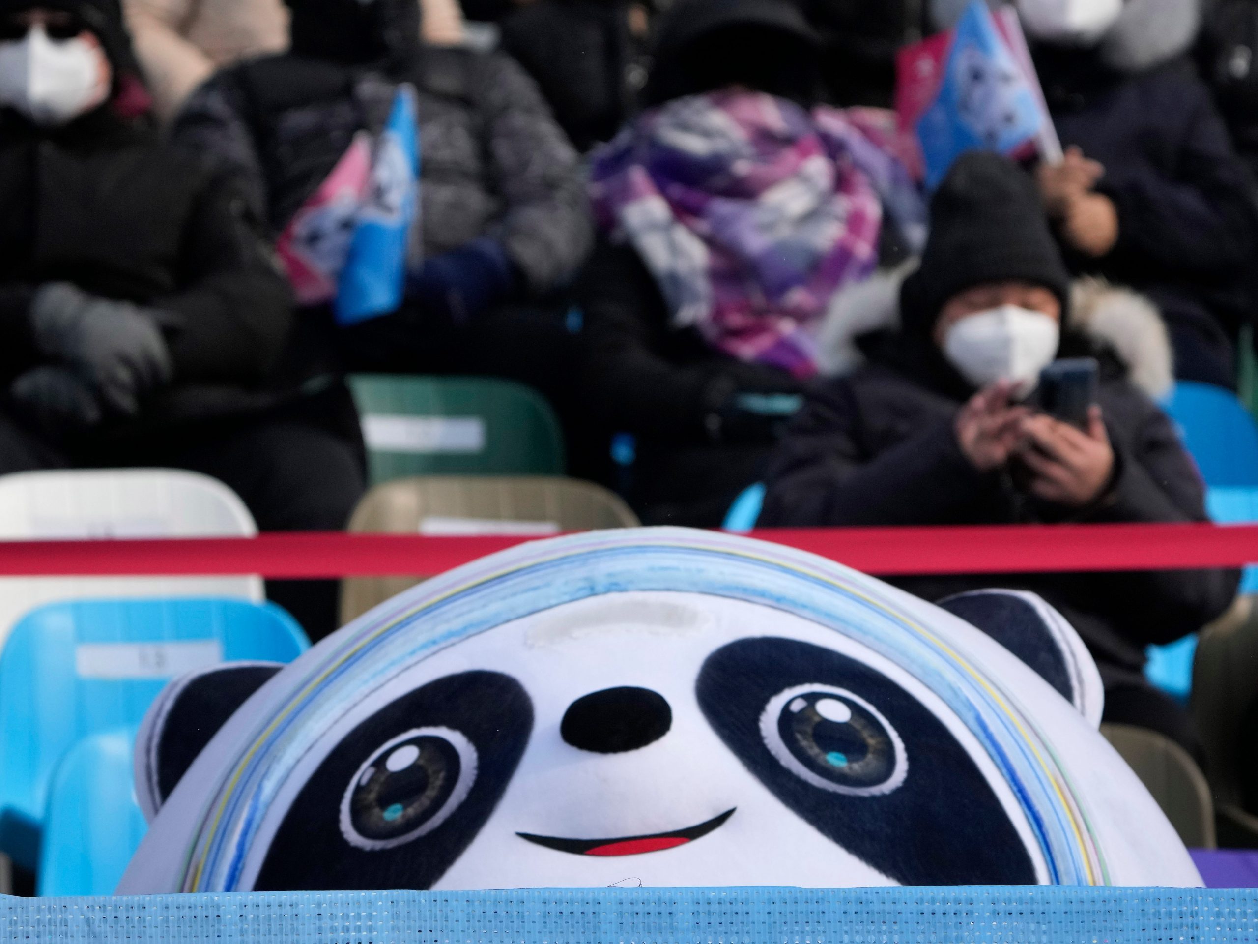 A stuffed Bing Dwen Dwen sits at the finish of the women's snowboard cross finals at the 2022 Winter Olympics, Wednesday, Feb. 9, 2022, in Zhangjiakou, China.