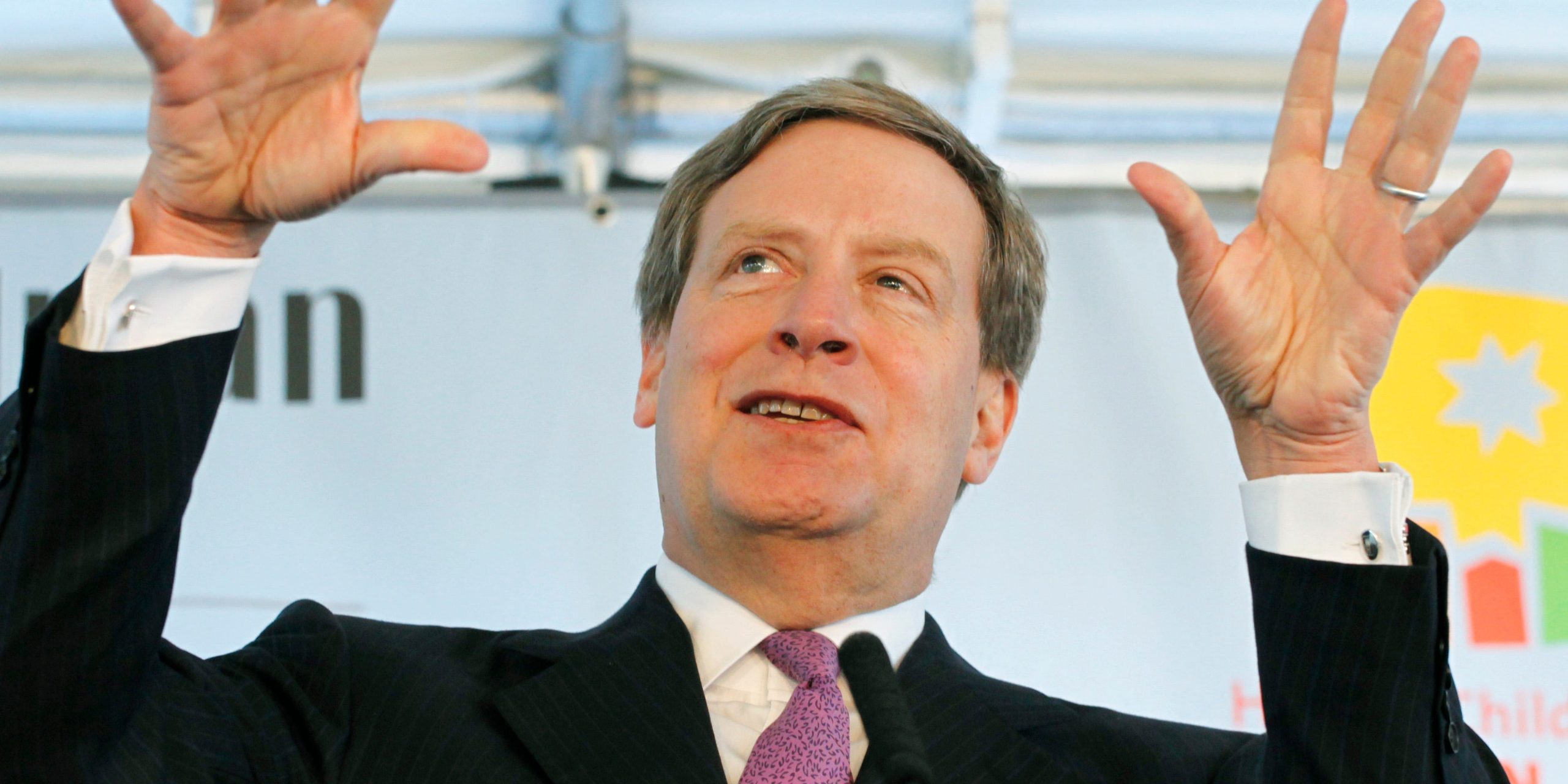 Stanley Druckenmiller, founder of hedge fund Duquesne Capital, holds his hands up in the air