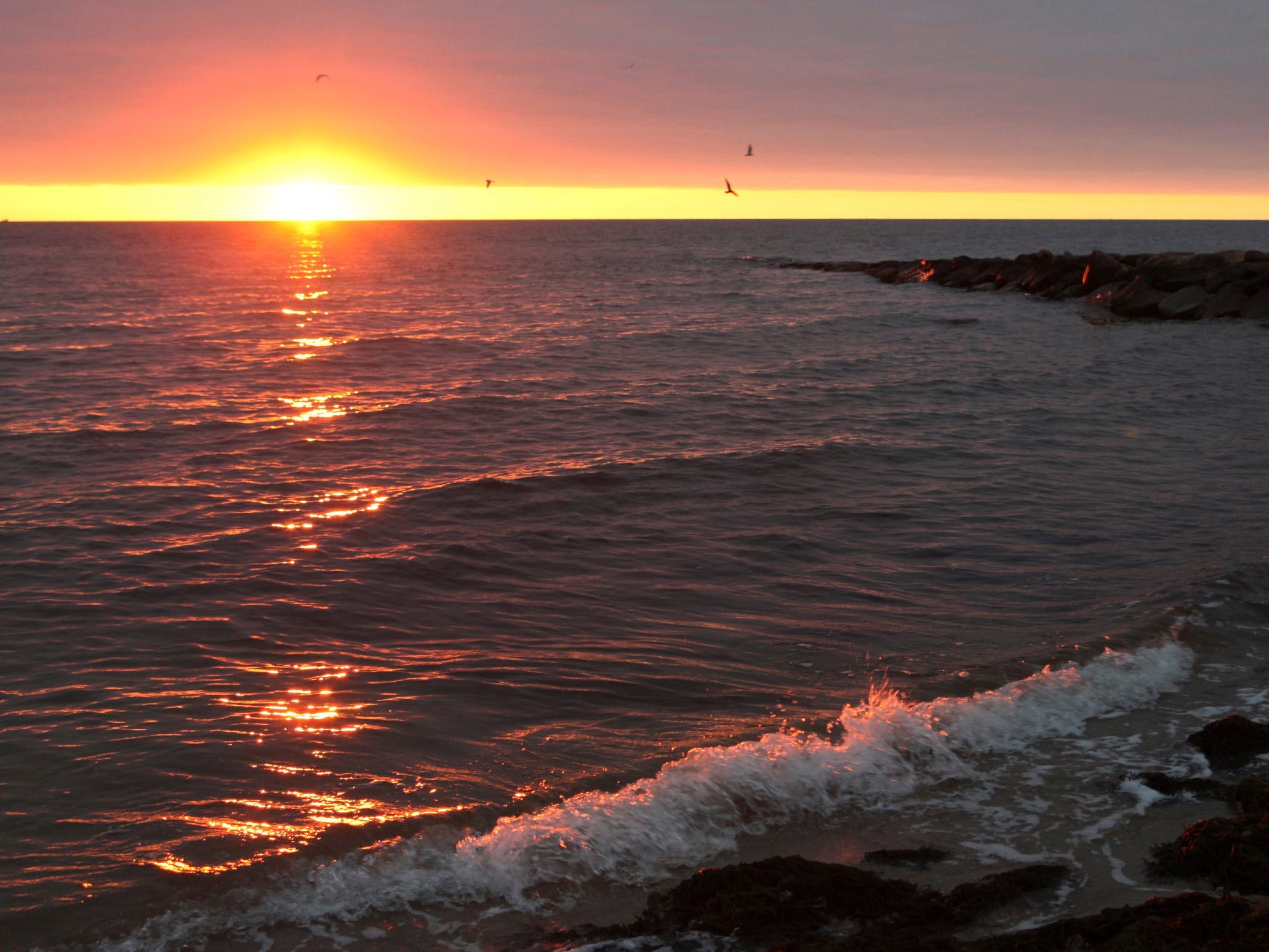 The sun rises over Nantucket Sound as seen from Popponesset Beach.