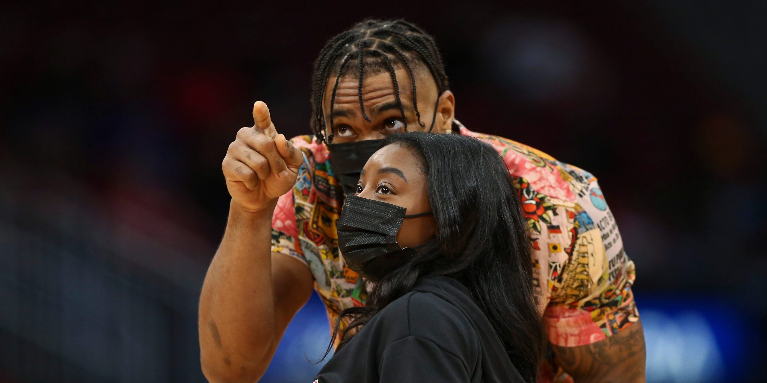 Olympic gold medalist gymnast Simone Biles and Houston Texans defensive back Jonathan Owens before the game between the Houston Rockets and the Los Angeles Lakers at Toyota Center.