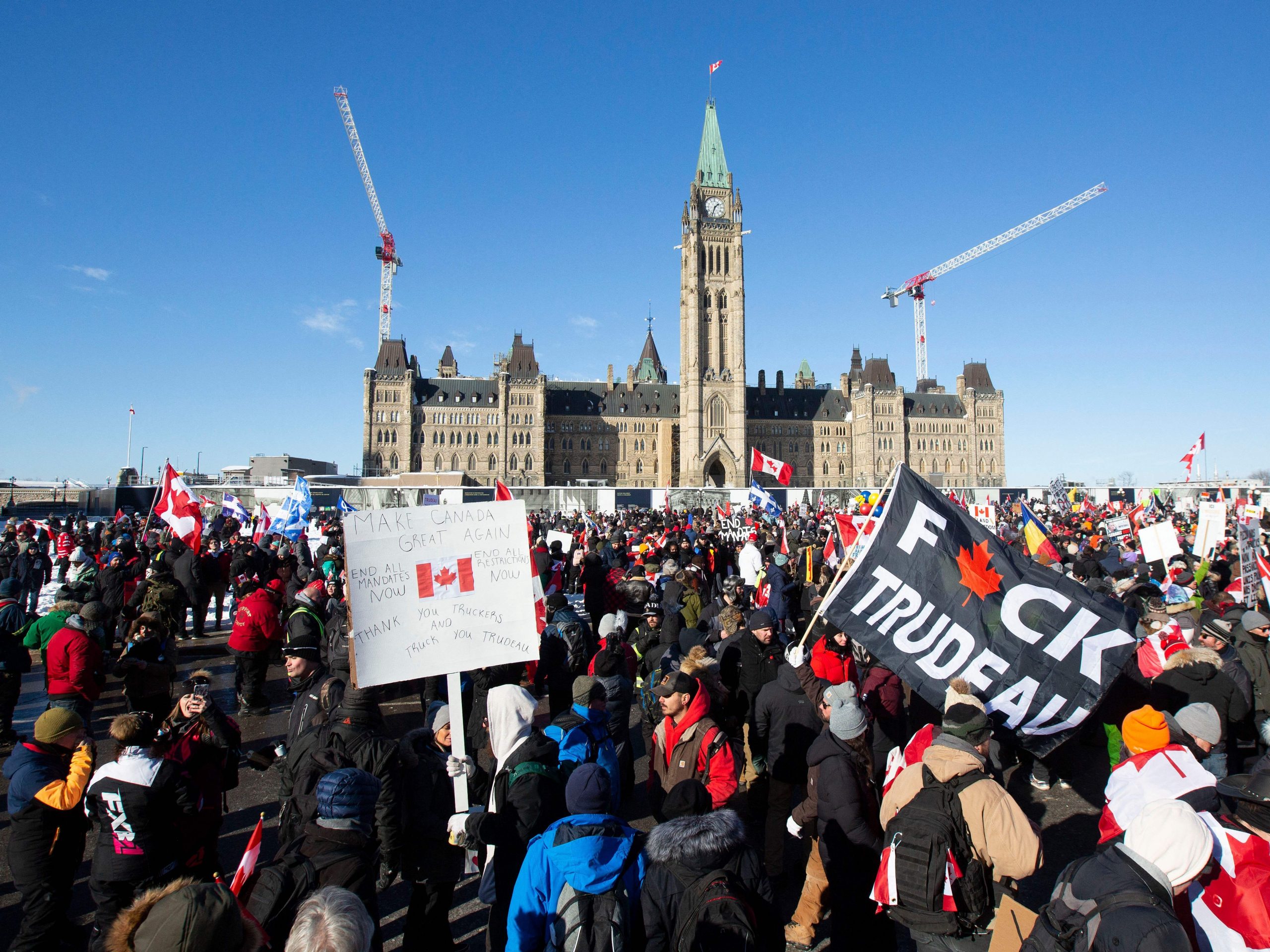 Supporters arrive at Parliament Hill for the Freedom Truck Convoy to protest against Covid-19 vaccine mandates and restrictions in Ottawa, Canada, on January 29, 2022. - Hundreds of truckers drove their giant rigs into the Canadian capital Ottawa on Saturday as part of a self-titled "Freedom Convoy" to protest vaccine mandates required to cross the US border.