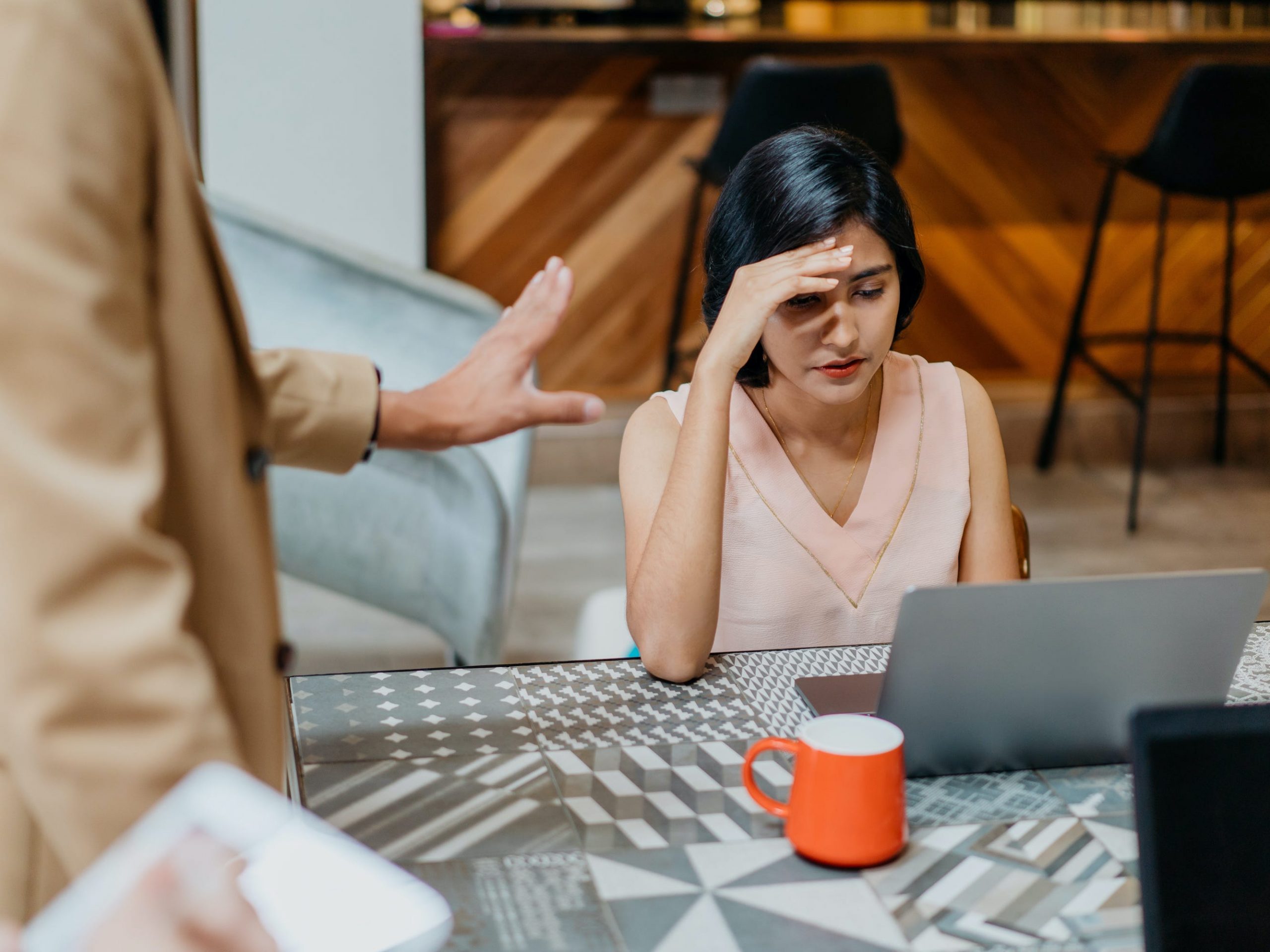 woman stress work annoyed upset coworker boss meeting on laptop