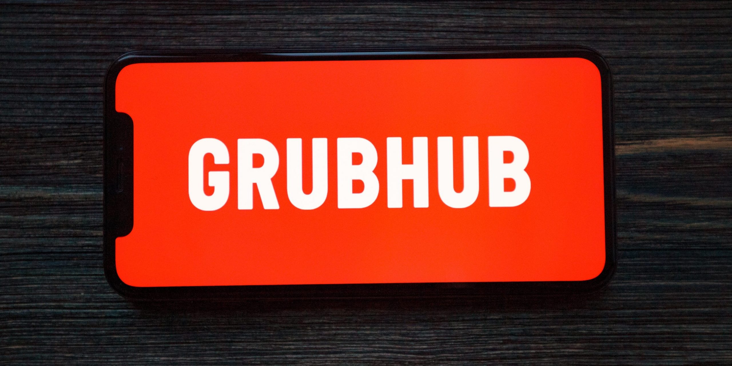 The Grubhub logo on an iPhone.