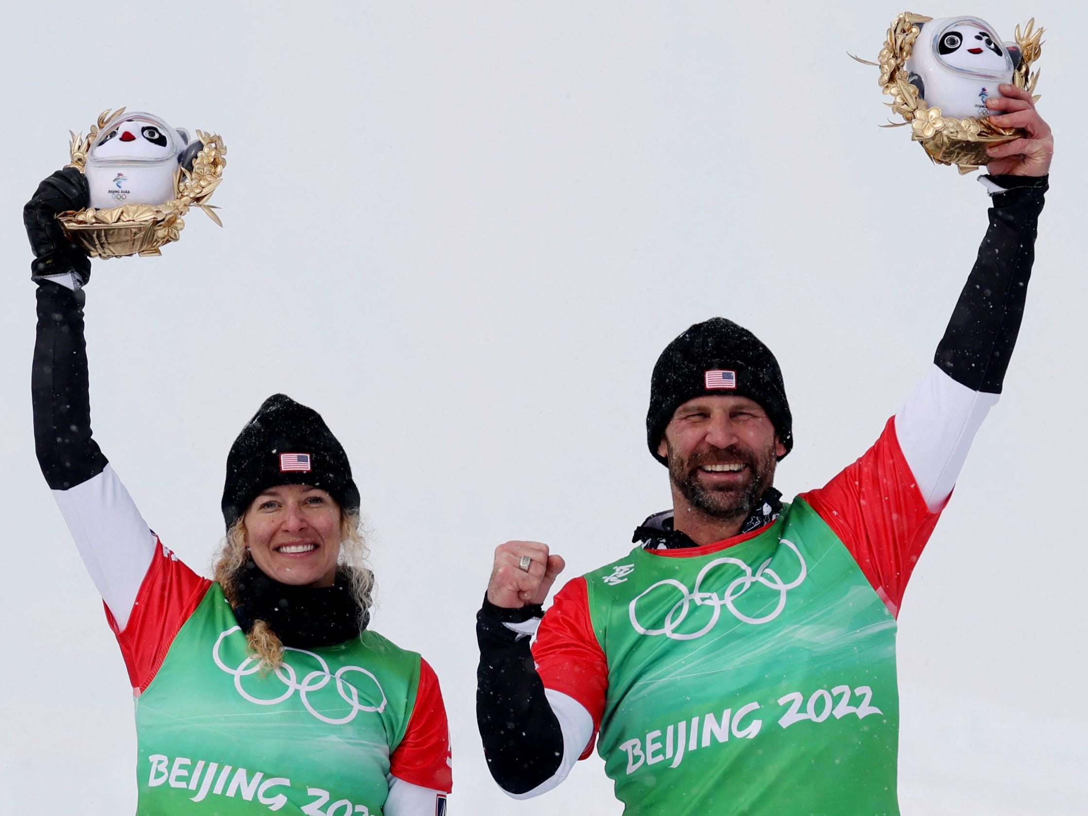 Gold medallists Nick Baumgartner and Lindsey Jacobellis of the United States celebrate during the flower ceremony