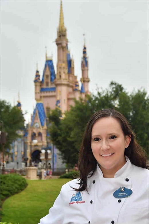 Chef Julia Thrash in the park, posing in front of one of the castles.