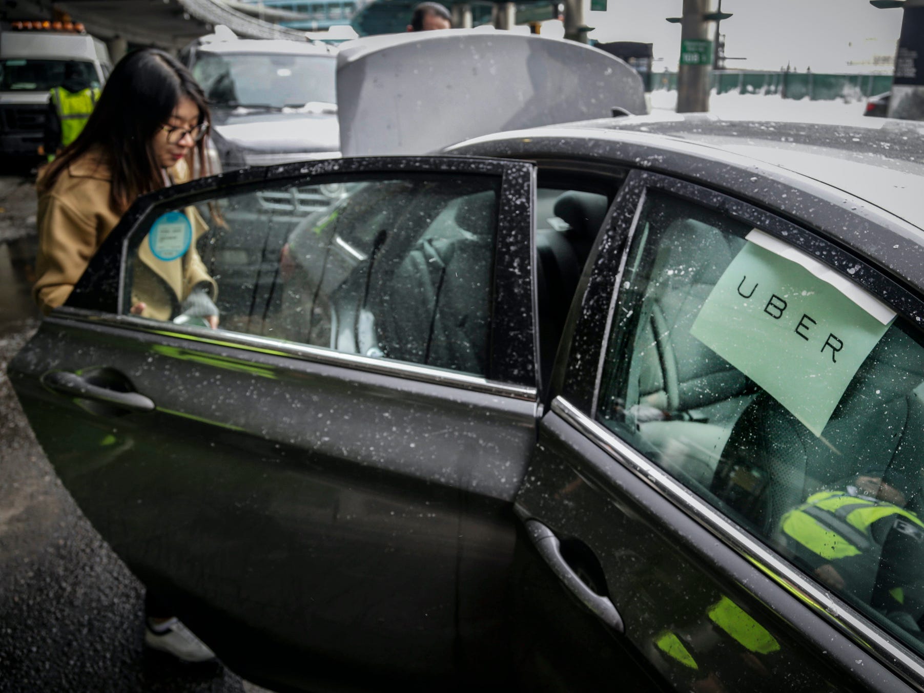 A passenger enters an Uber at LaGuardia Airport in New York, March 15, 2017.