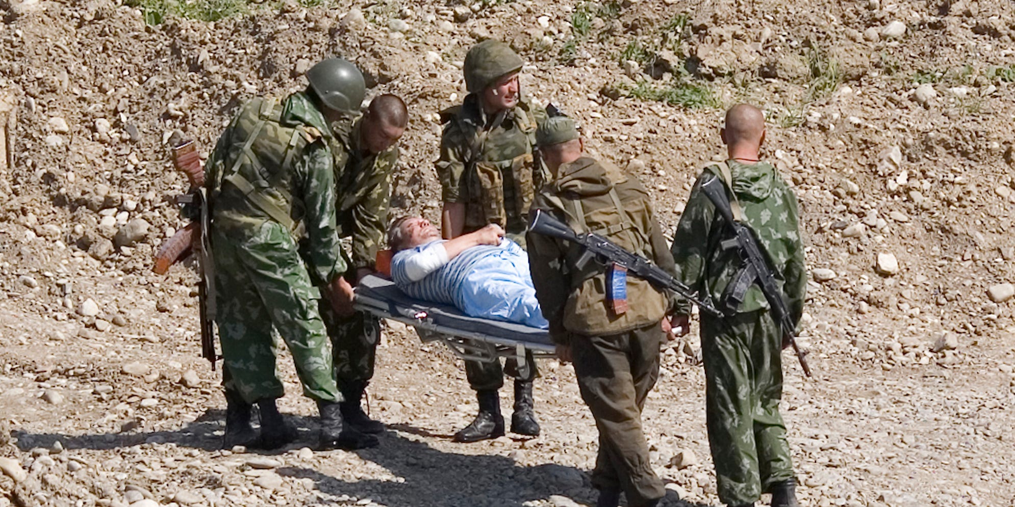 Russian soldiers carry a wounded pilot to a helicopter on the road from Tbilisi to Gori, on August 19, 2008