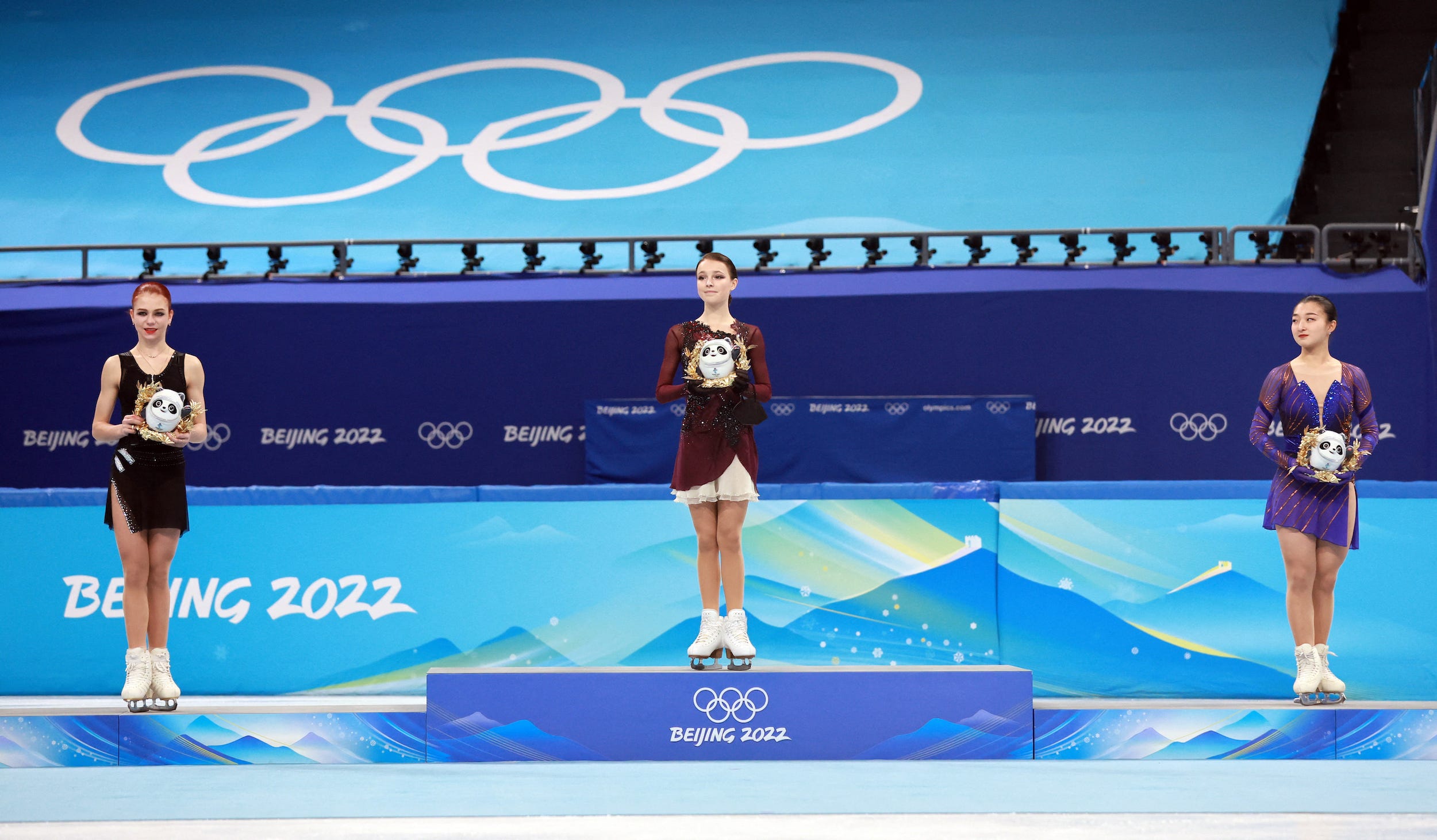 Medalists mount the podium following the women's free skate at the Beijing Olympics.