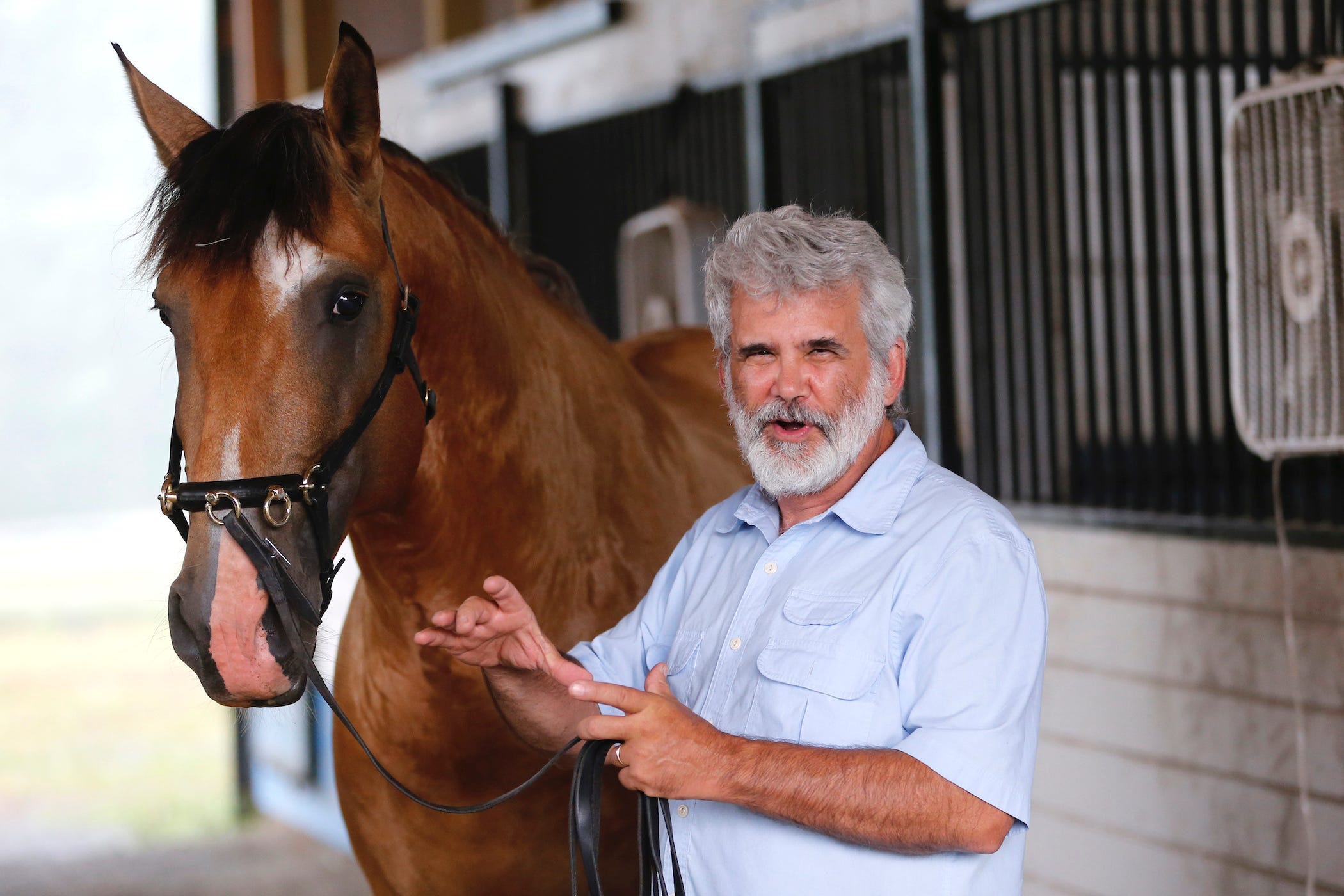 robert malone on his farm with his horse