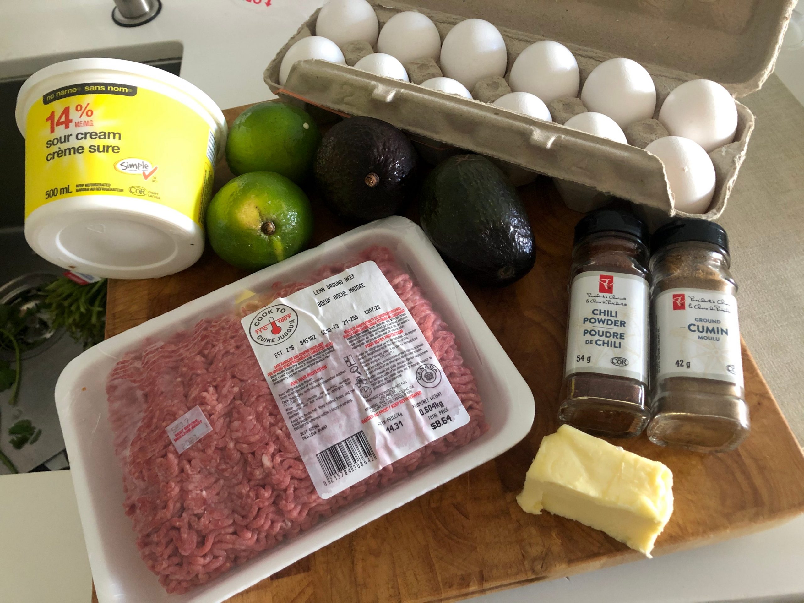 The ingredients for Gordon Ramsay's breakfast burrito laid out on wooden cutting board