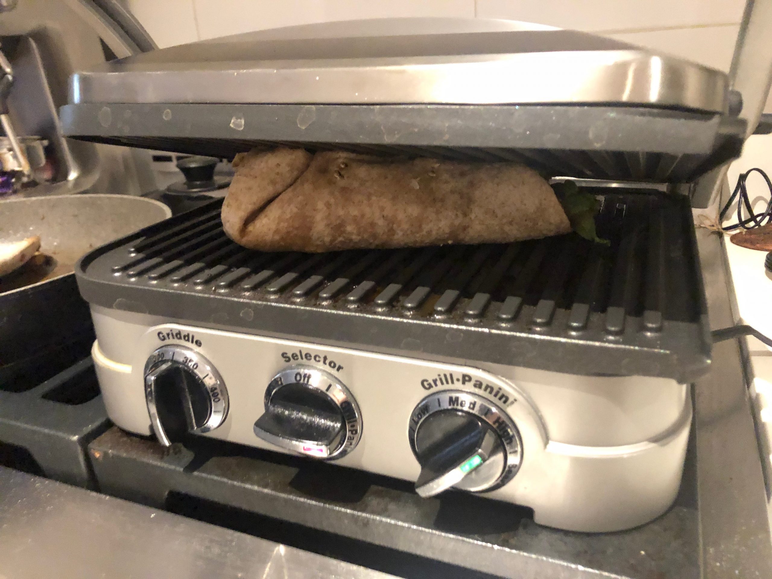 Cooking the folded and assembled burrito in panini press