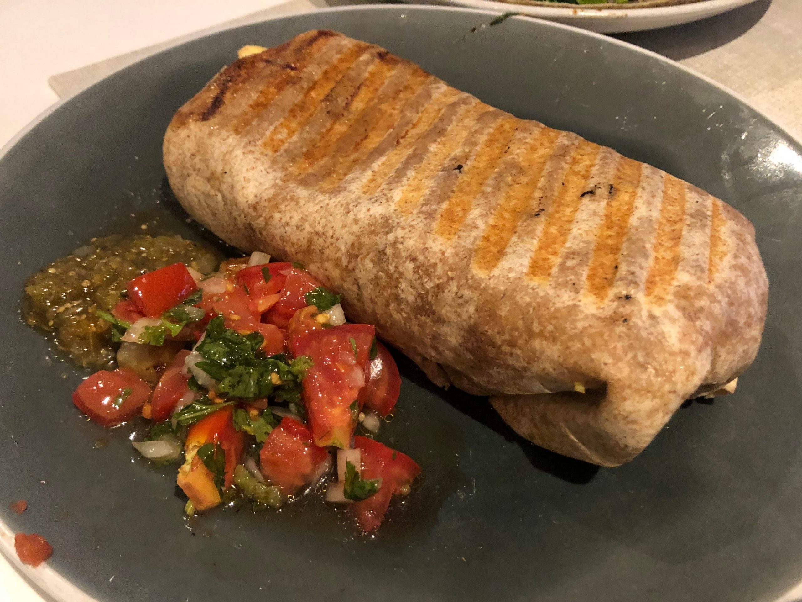 Guy Fieri breakfast burrito on plate with salsa