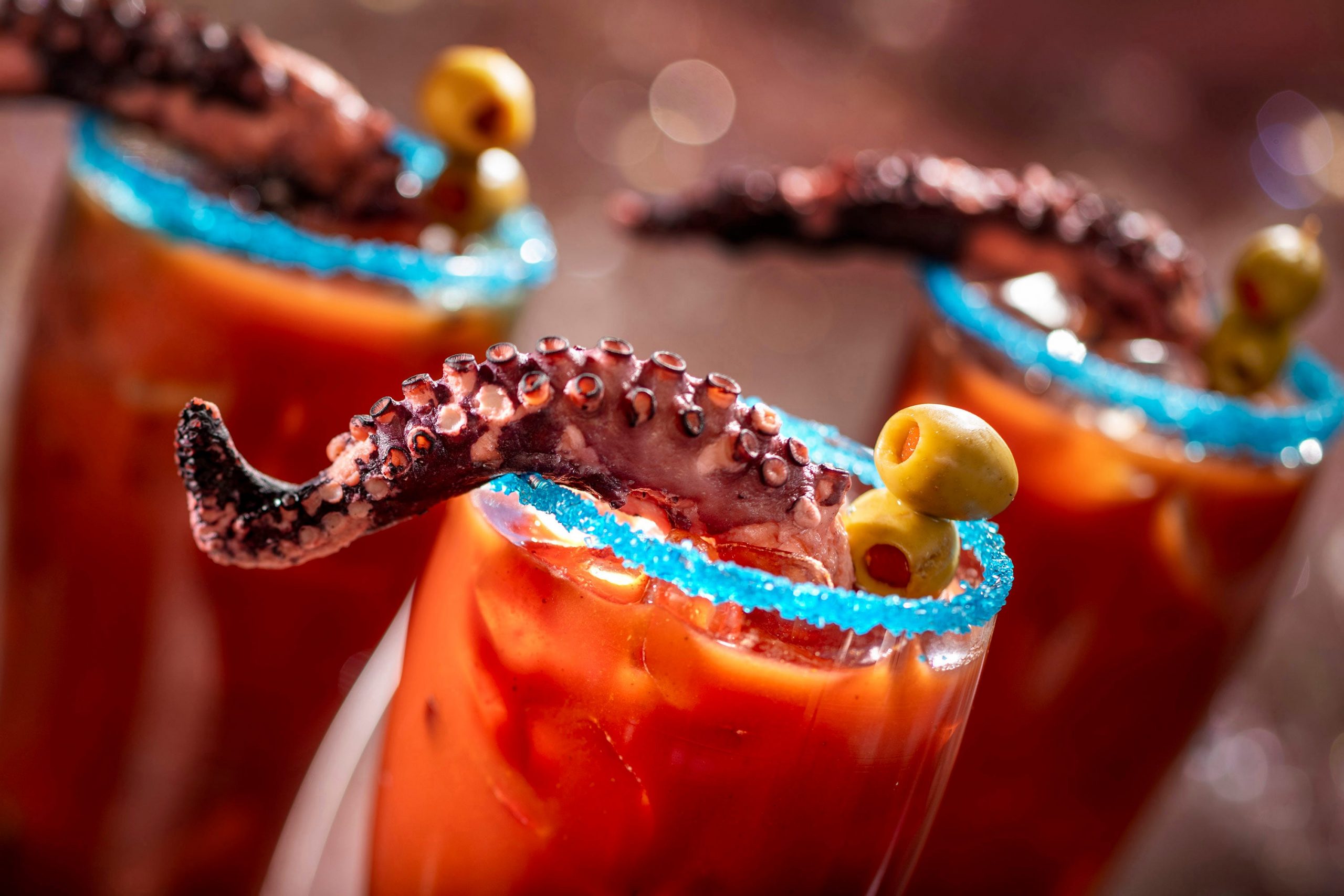 One of Disney's culinary creations, which is red drink with blue coating around the rim of the glass, with tentacles sticking out of the top.