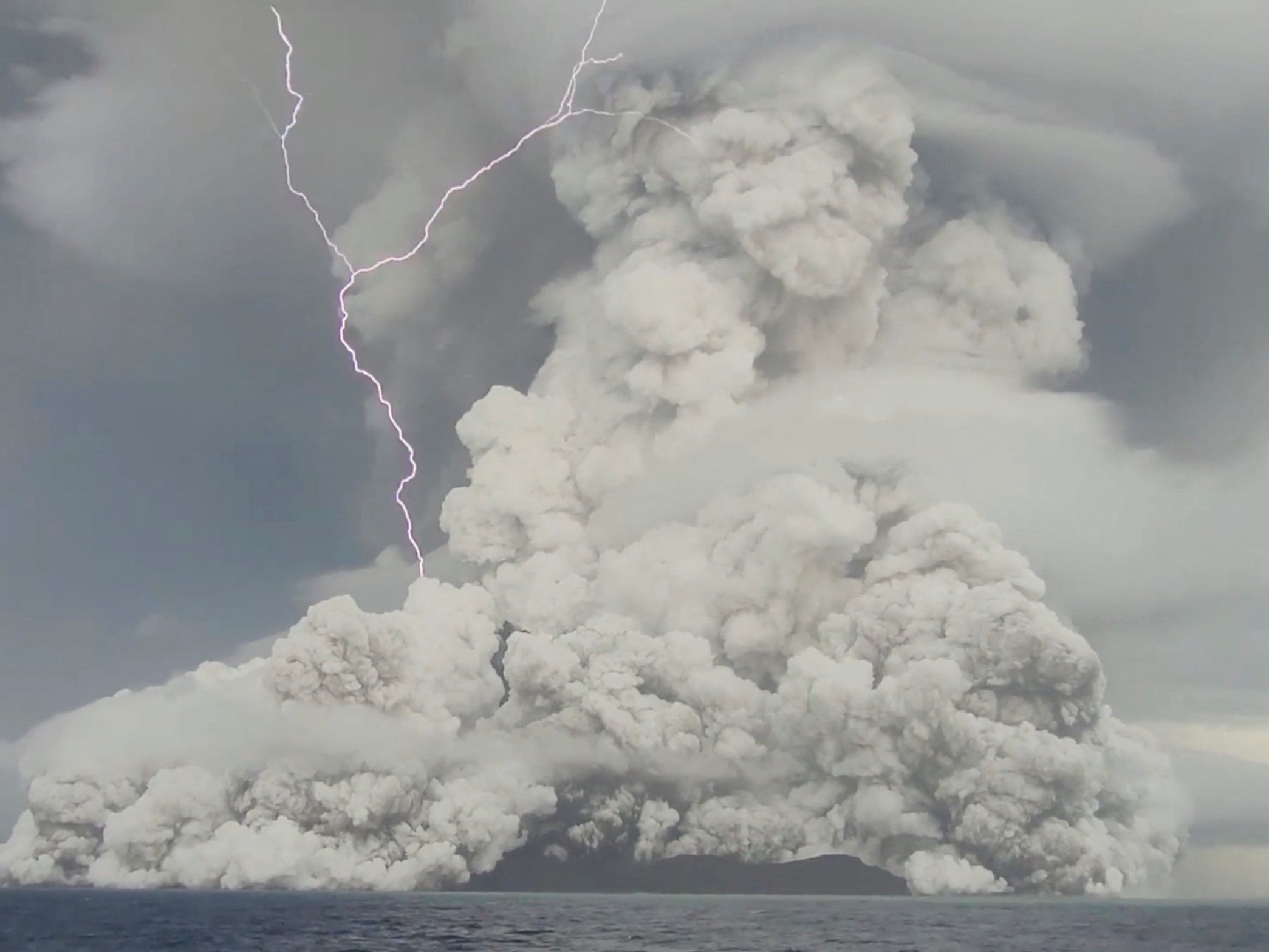 Hunga Tonga-Hunga Ha'apai volcano erupting cloud of ash with lightning strike
