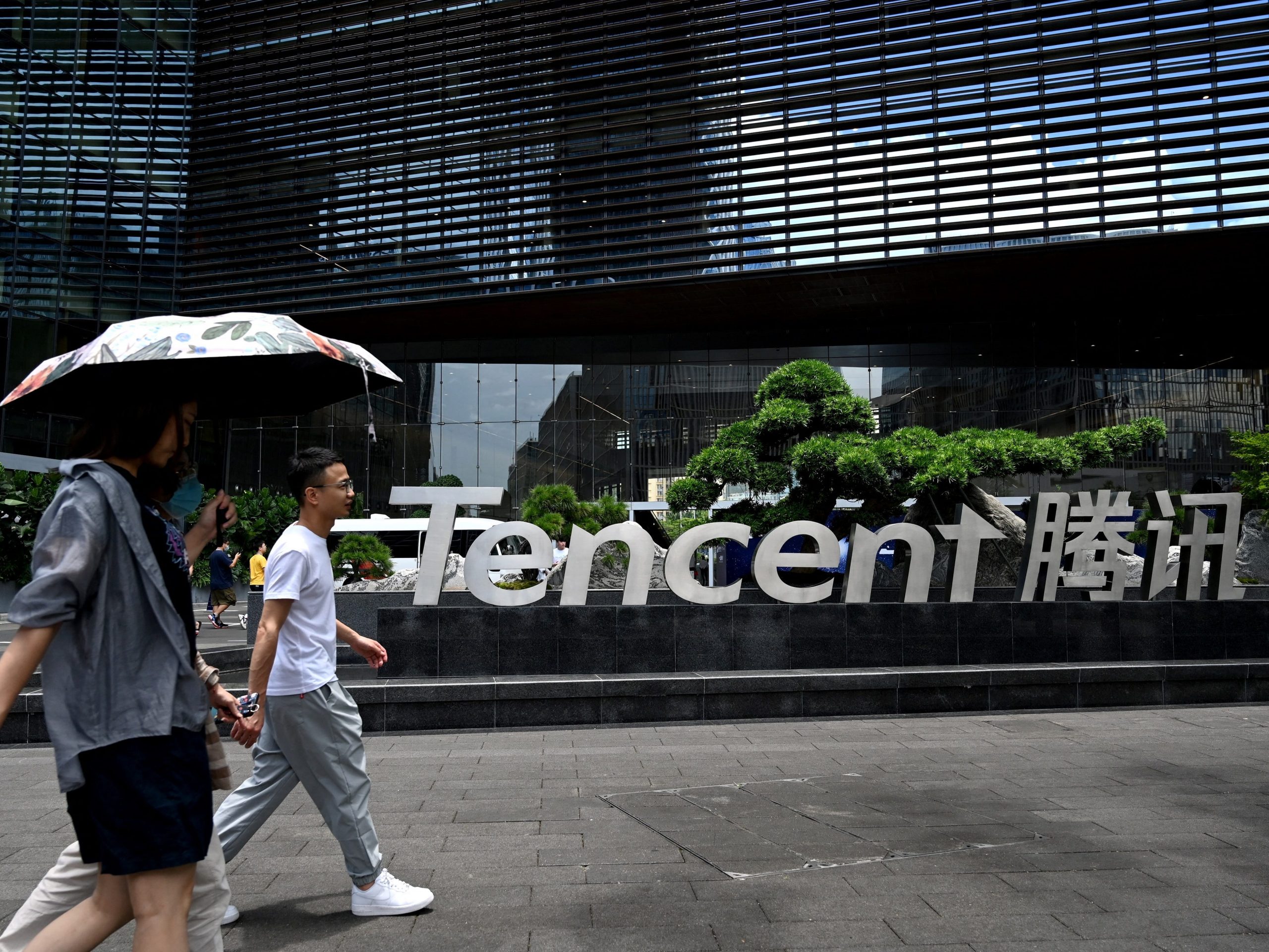 This photo from May 2021 shows people walking past the Tencent headquarters in the southern Chinese city of Shenzhen, in Guangdong province