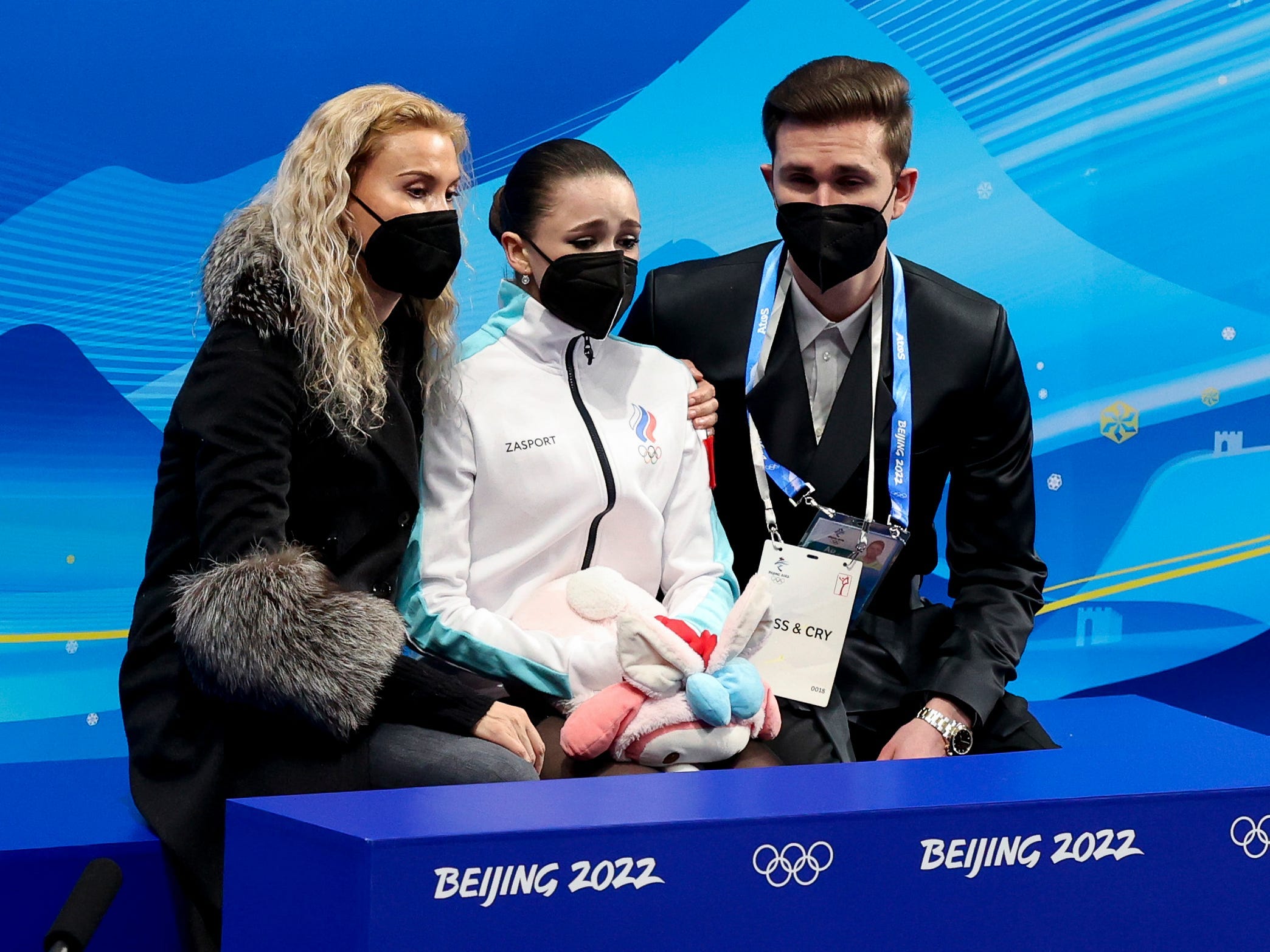 Eteri Tutberidze wraps her hand around Kamila Valieva's shoulder after the teen's performance.