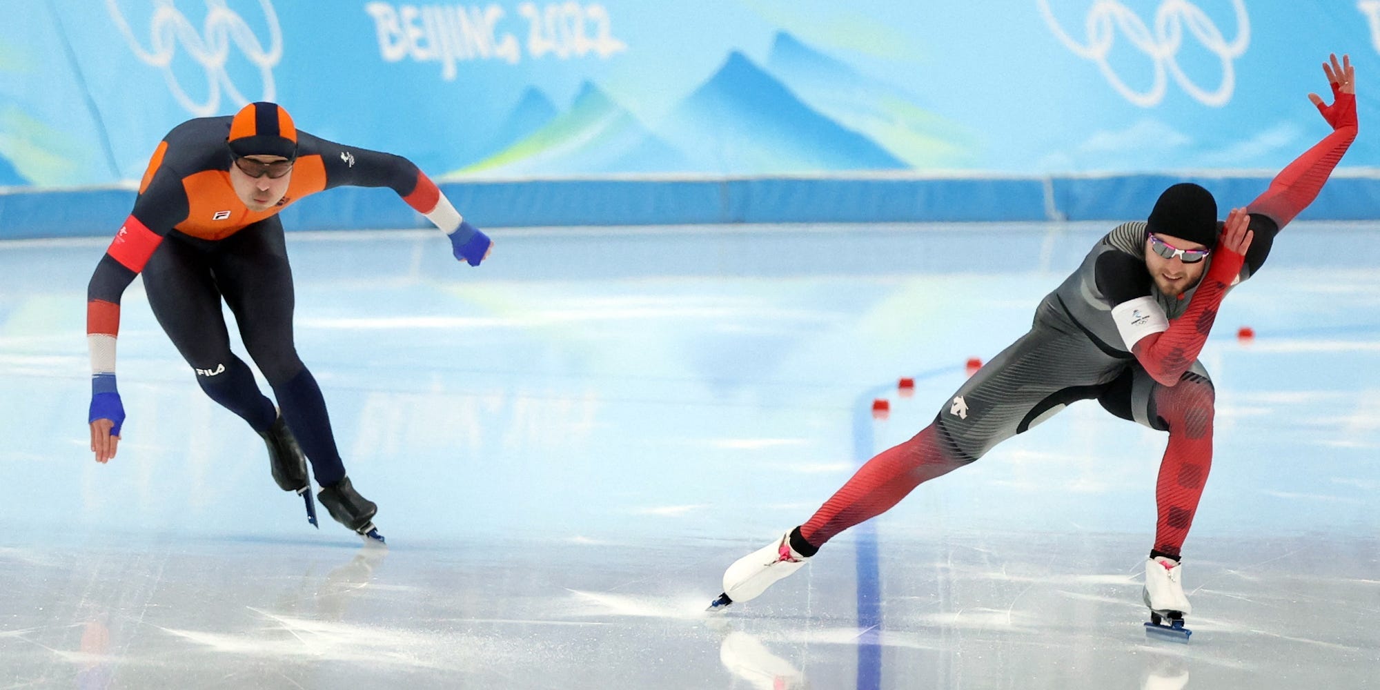 Kai Verbij races to the right of Laurent Dubreuil in the 1,000 meter speed skate at the Beijing Olympics.