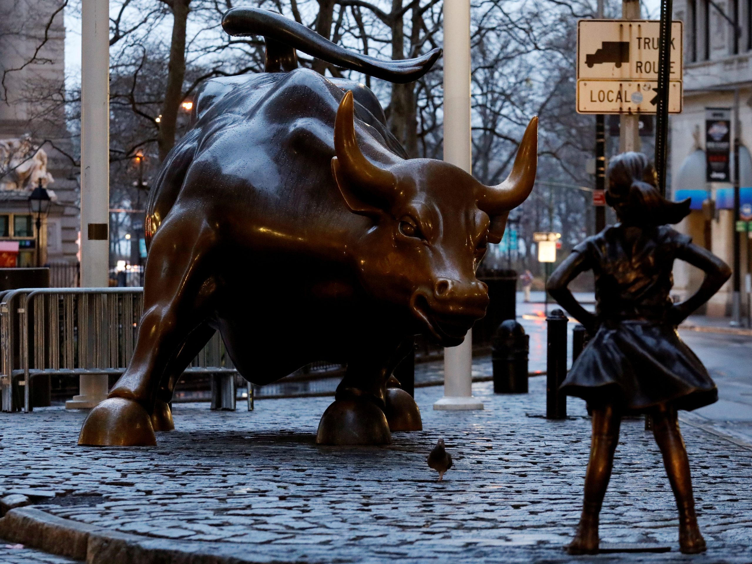 A statue of a girl facing the Wall St. Bull is seen in the financial district in New York