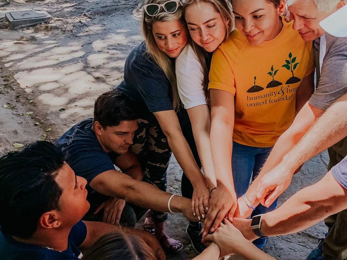 Image of people with their hands in the middle of a circle for generous coffee review 2022