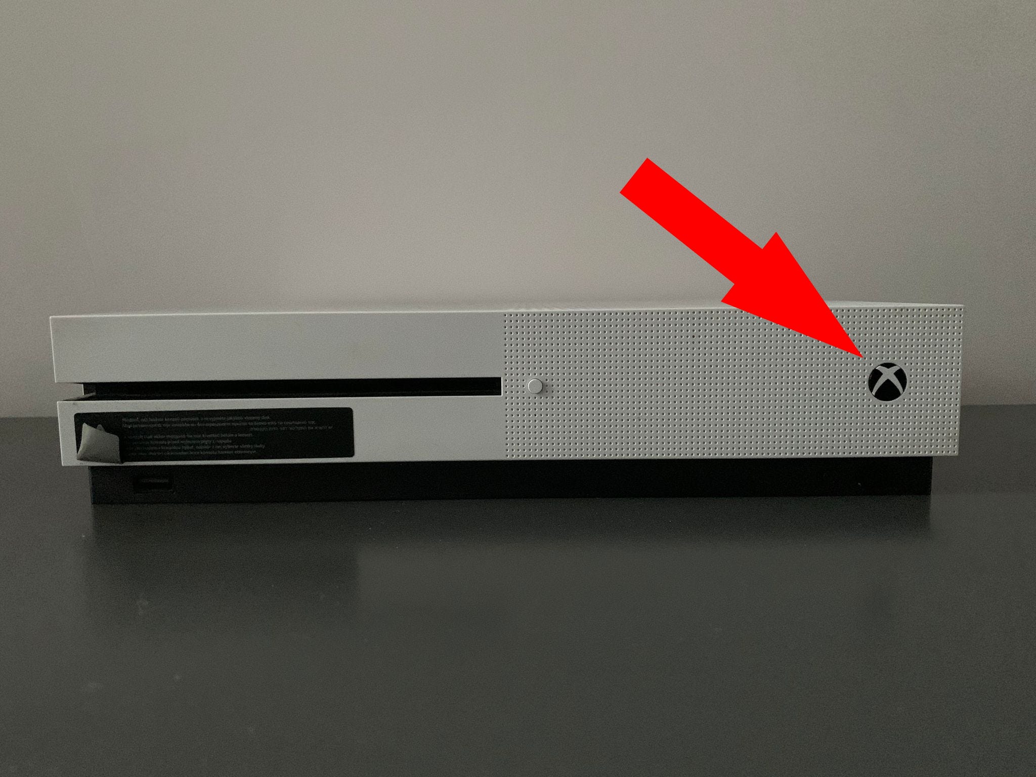 A picture of an Xbox One console with the "Power" button highlighted.