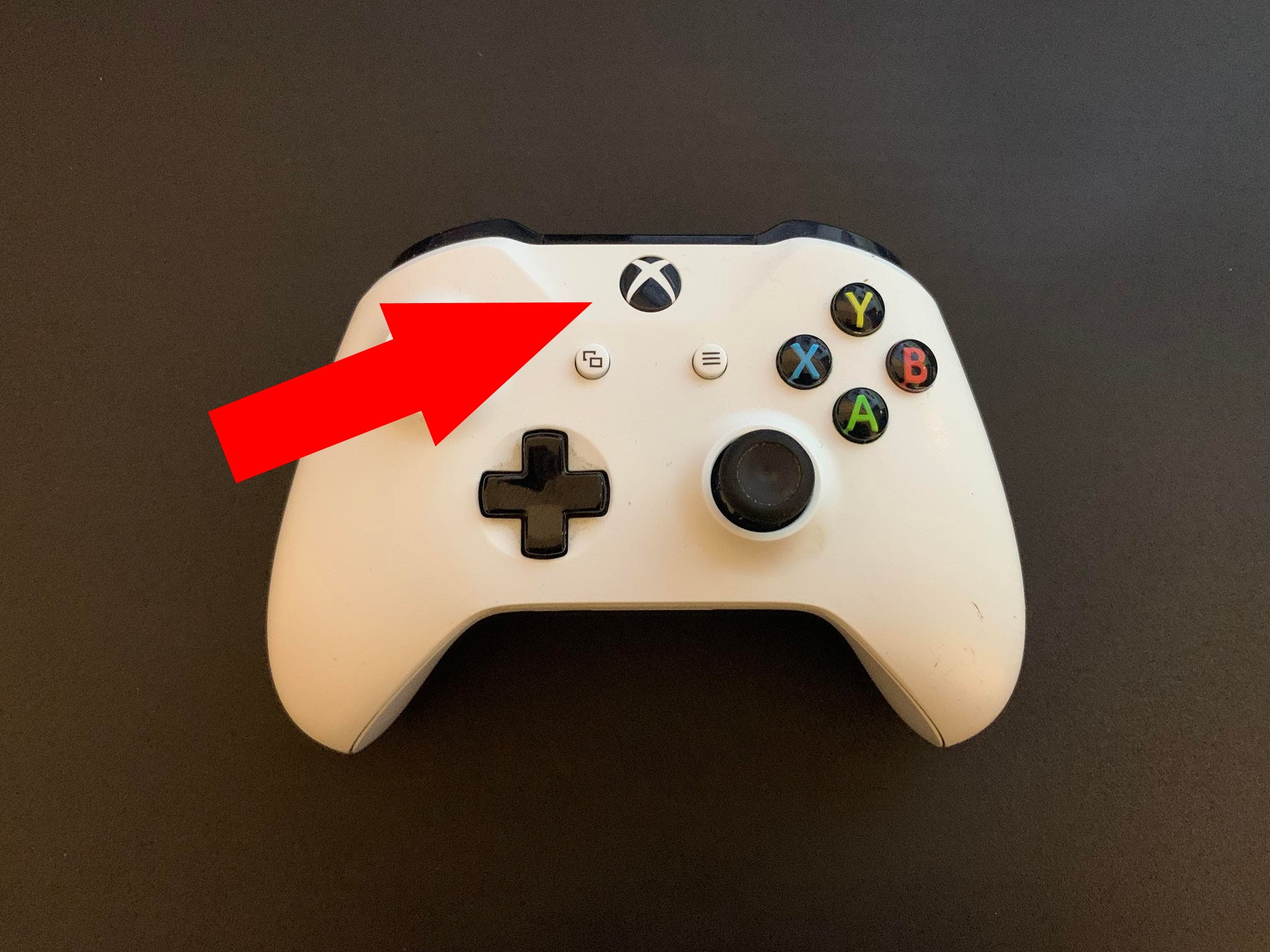 A picture of an Xbox One controller with the "Xbox button" highlighted.