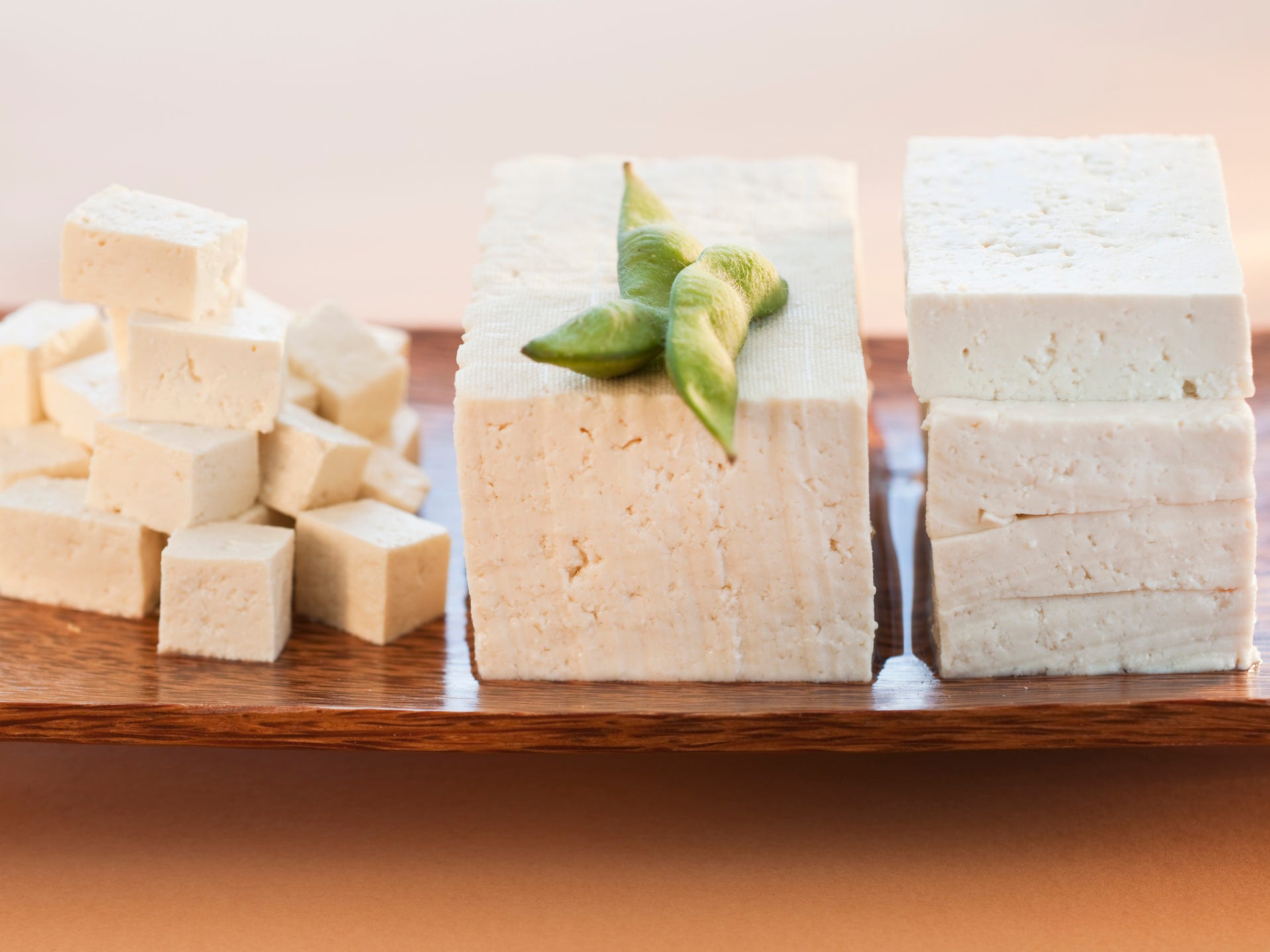 Tofu stacks on a wooden board