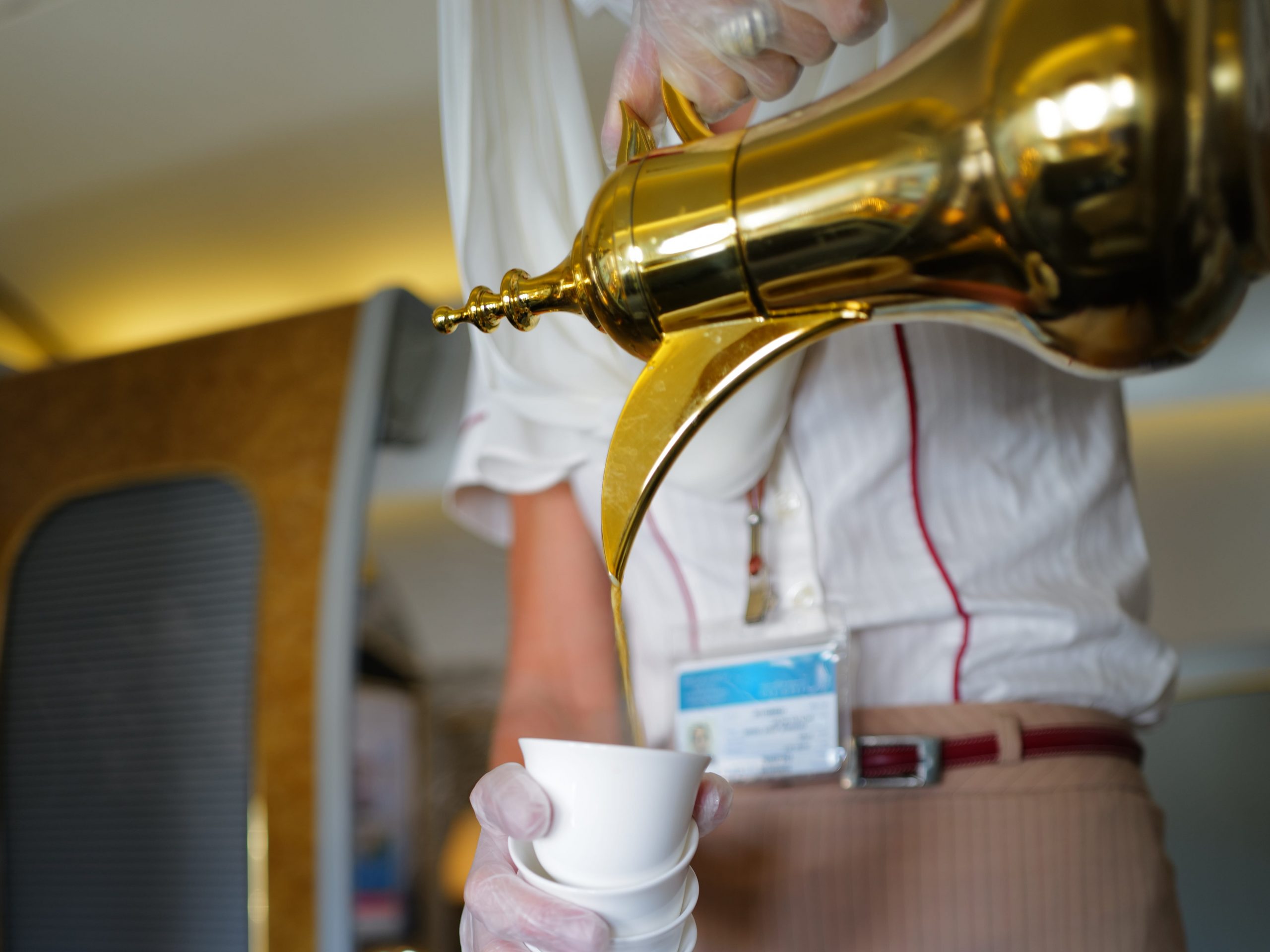 Flight attendant pouring out of dallah