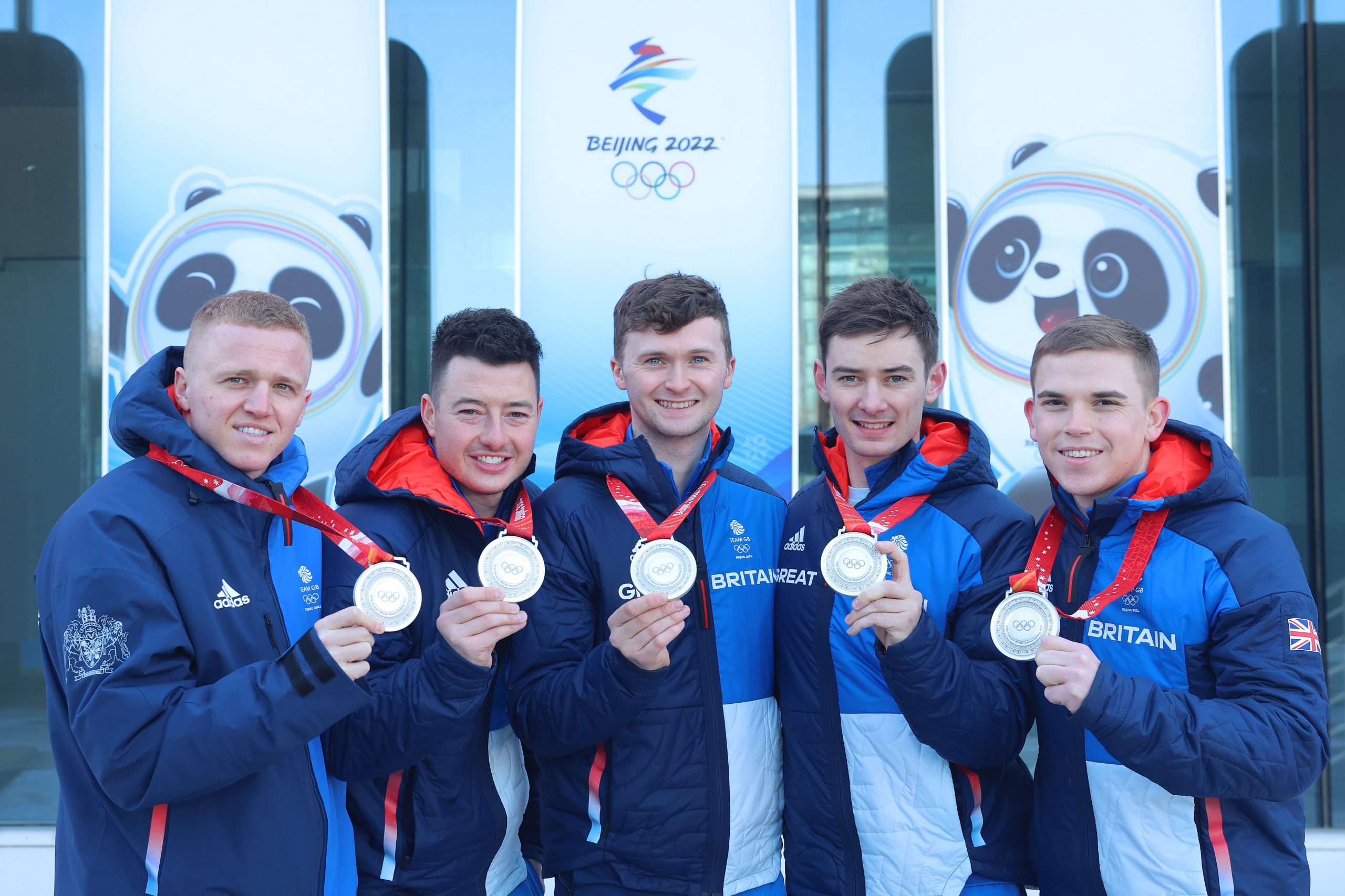 Team Great Britain's Men's Curling team poses with silver medals at Winter Olympics.