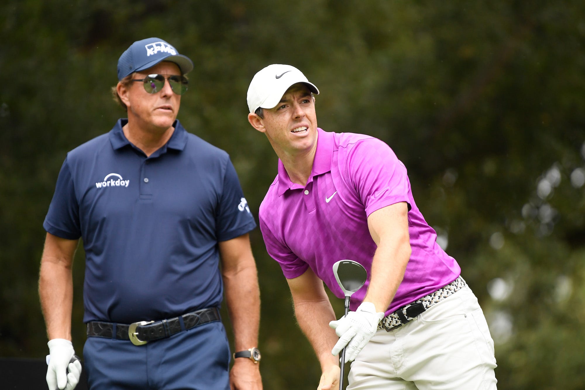 Rory McIlroy of Northern Ireland watches his shot from the sixth tee as Phil Mickelson of the United States looks on during the first round of the Zozo Championship @ Sherwood