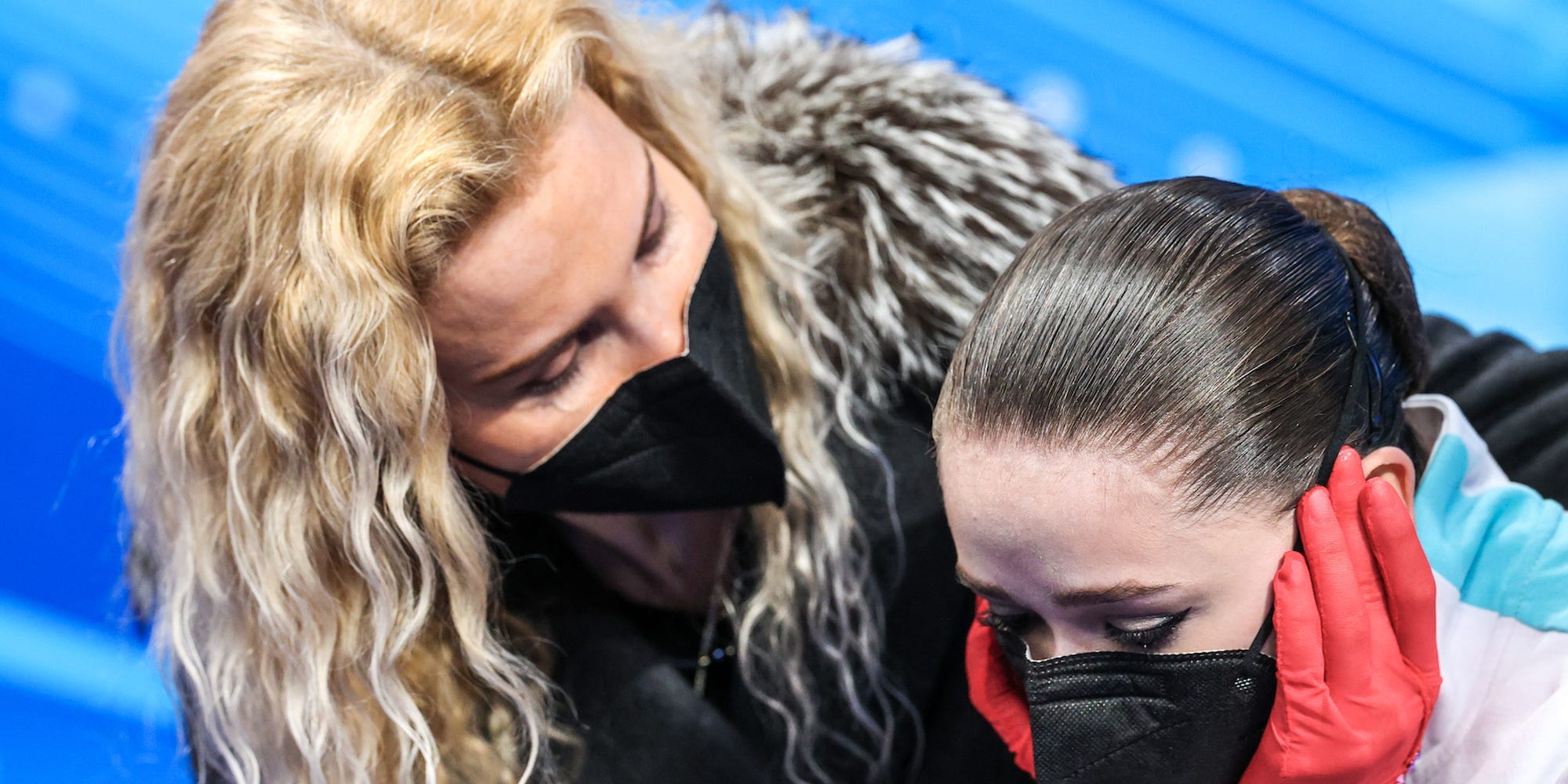 Coach Eteri Tutberidze (L) and figure skater Kamila Valiyeva of Team ROC are seen after Valiyeva's performance in the women's free skating programme at the Capital Indoor Stadium at the 2022 Winter Olympic Games.