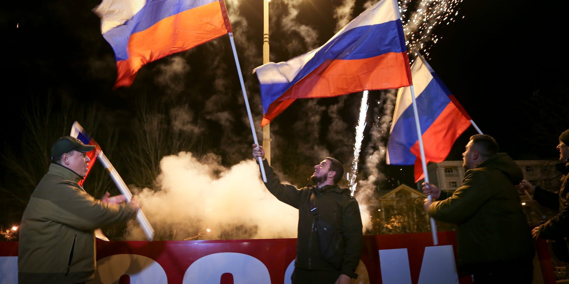People wave Russian national flags on February 21, 2022.