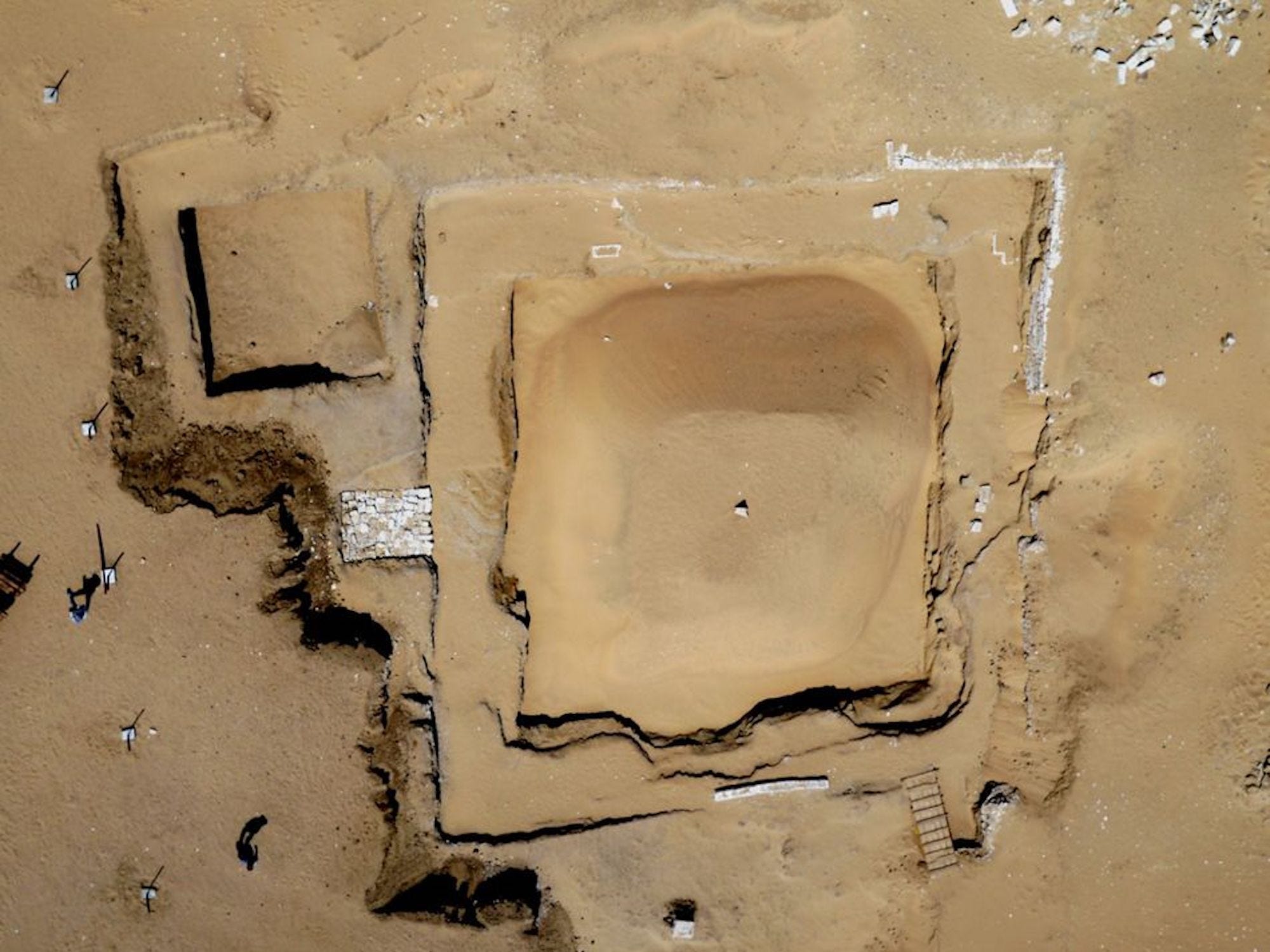 An aerial view of the site shows the embalming shaft next to the bigger tomb, the later still being covered