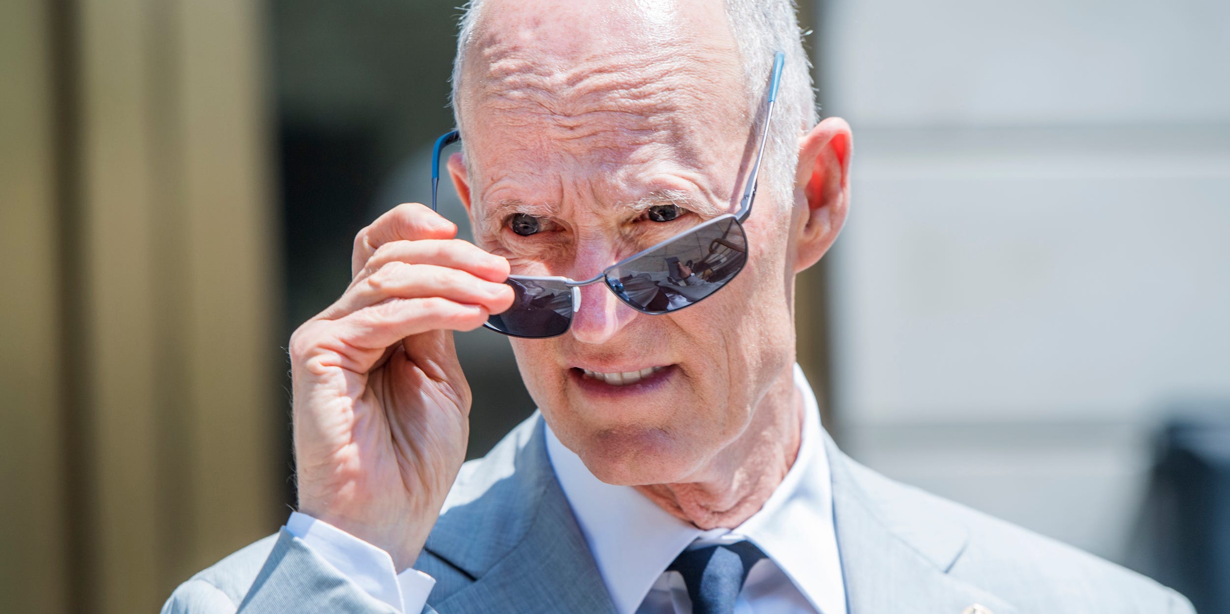 Rick Scott lowers his sunglasses