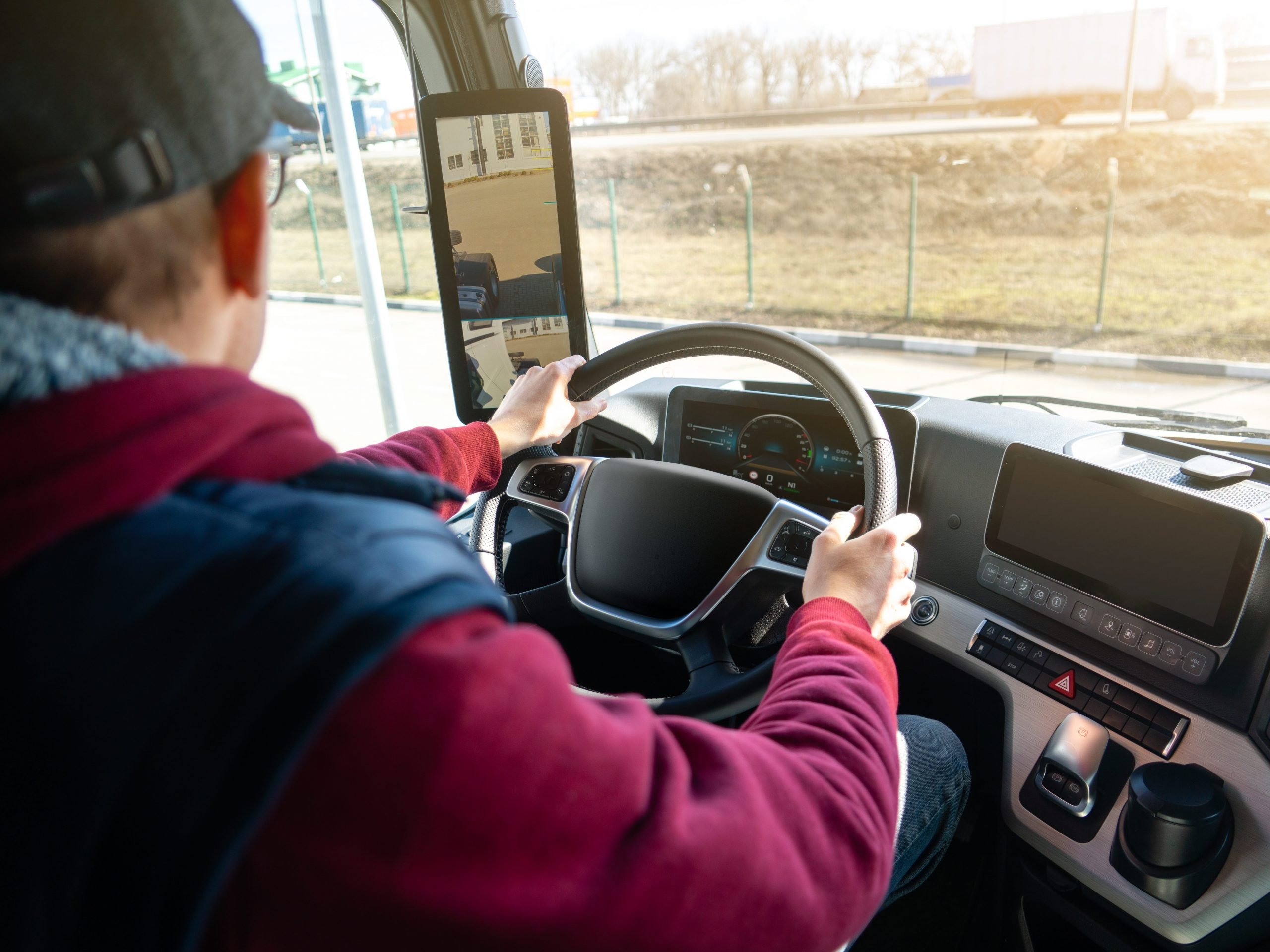 Man driving a truck with rear view camera