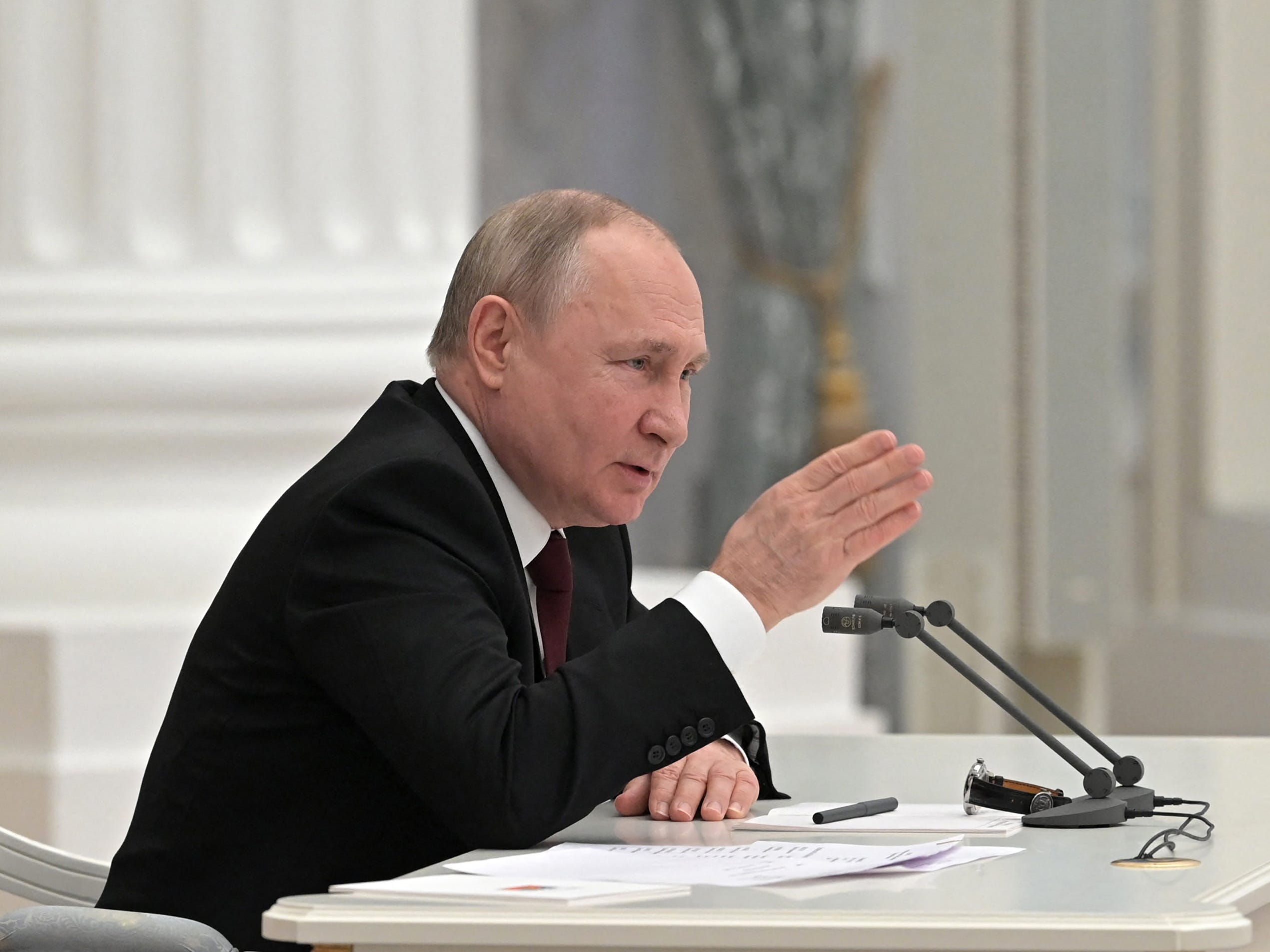 Russian President Vladimir Putin chairs a meeting with members of the Security Council in Moscow on February 21, 2022.