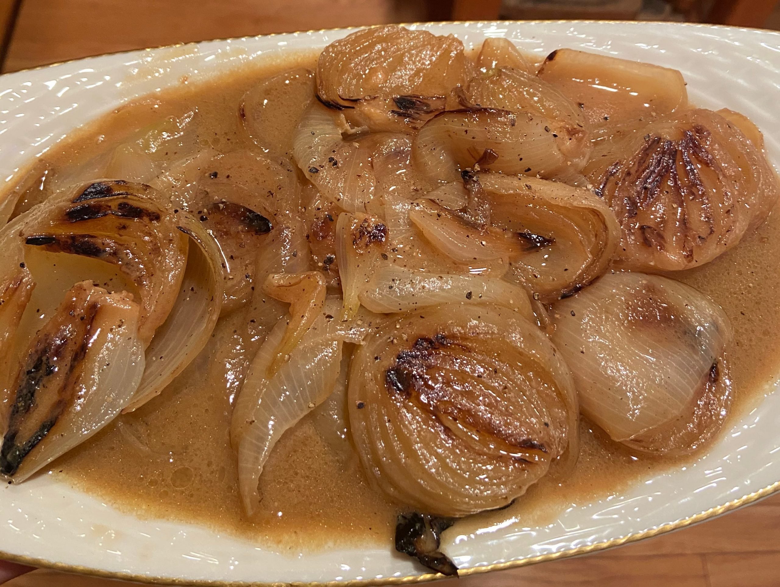 Butter-miso braised onions plated on white dish