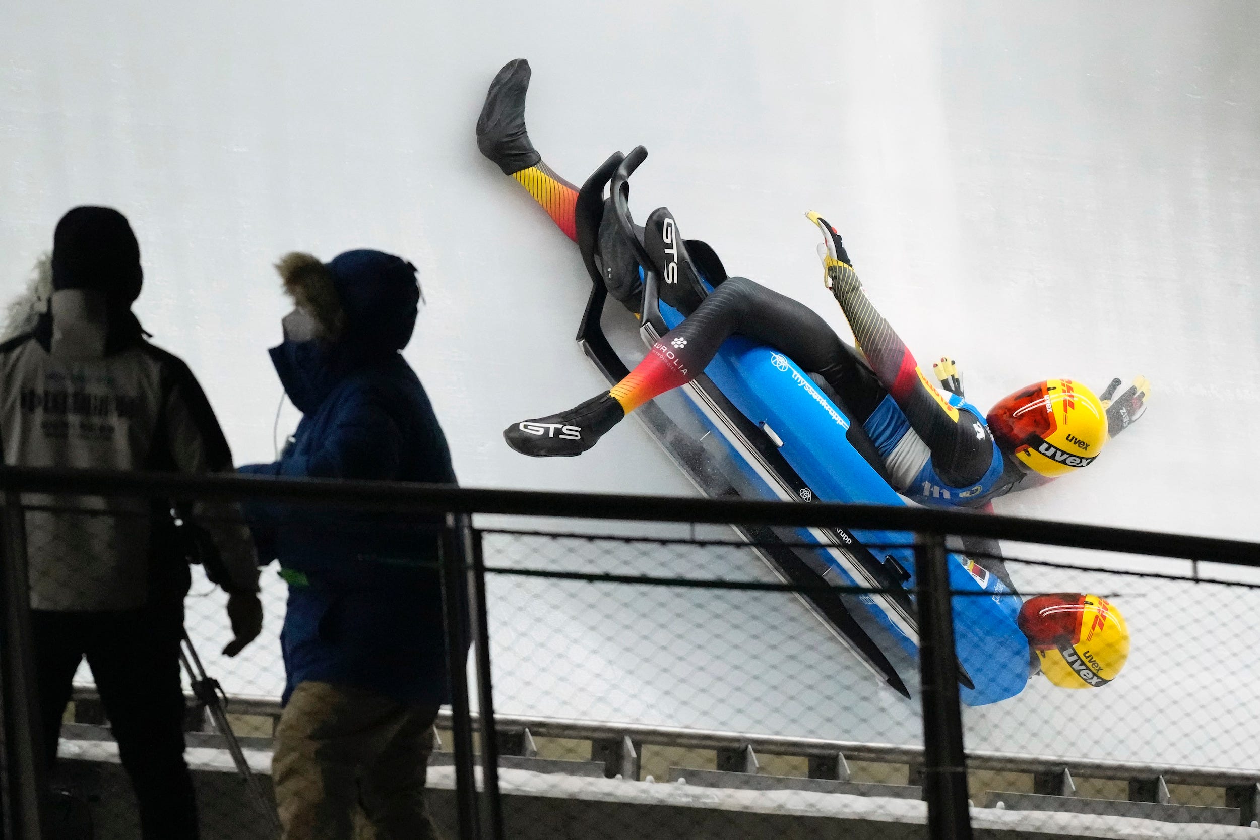 Two German athletes suffer a crash during a luge event.