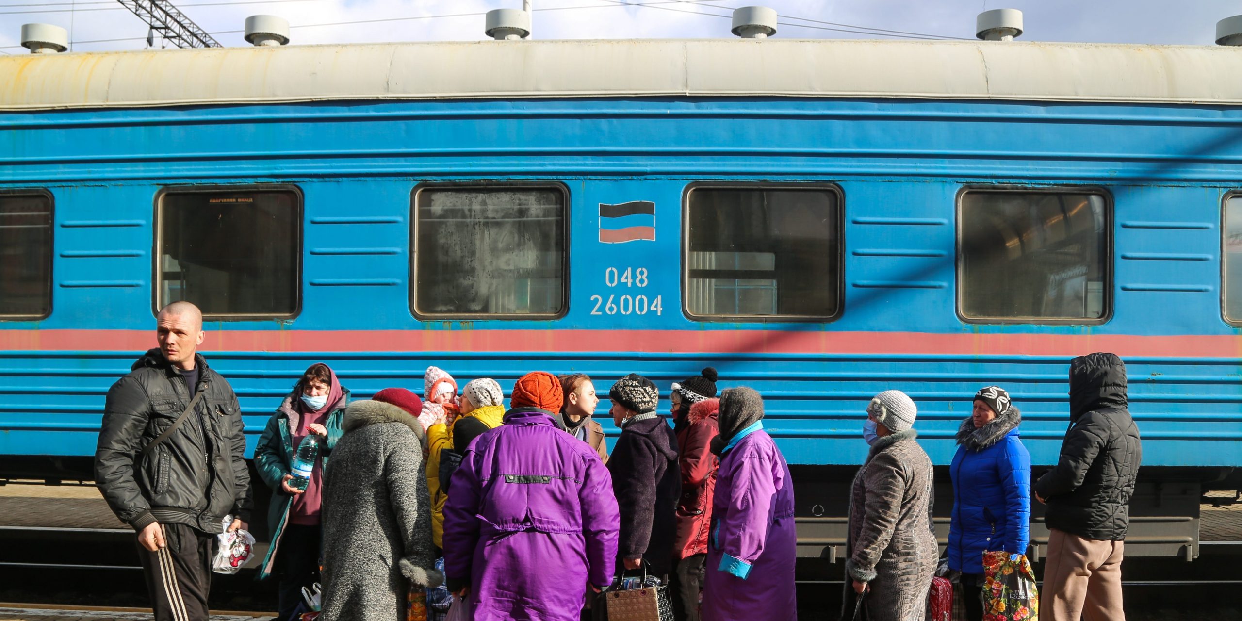 Ukrainian citizens wait outside a train.