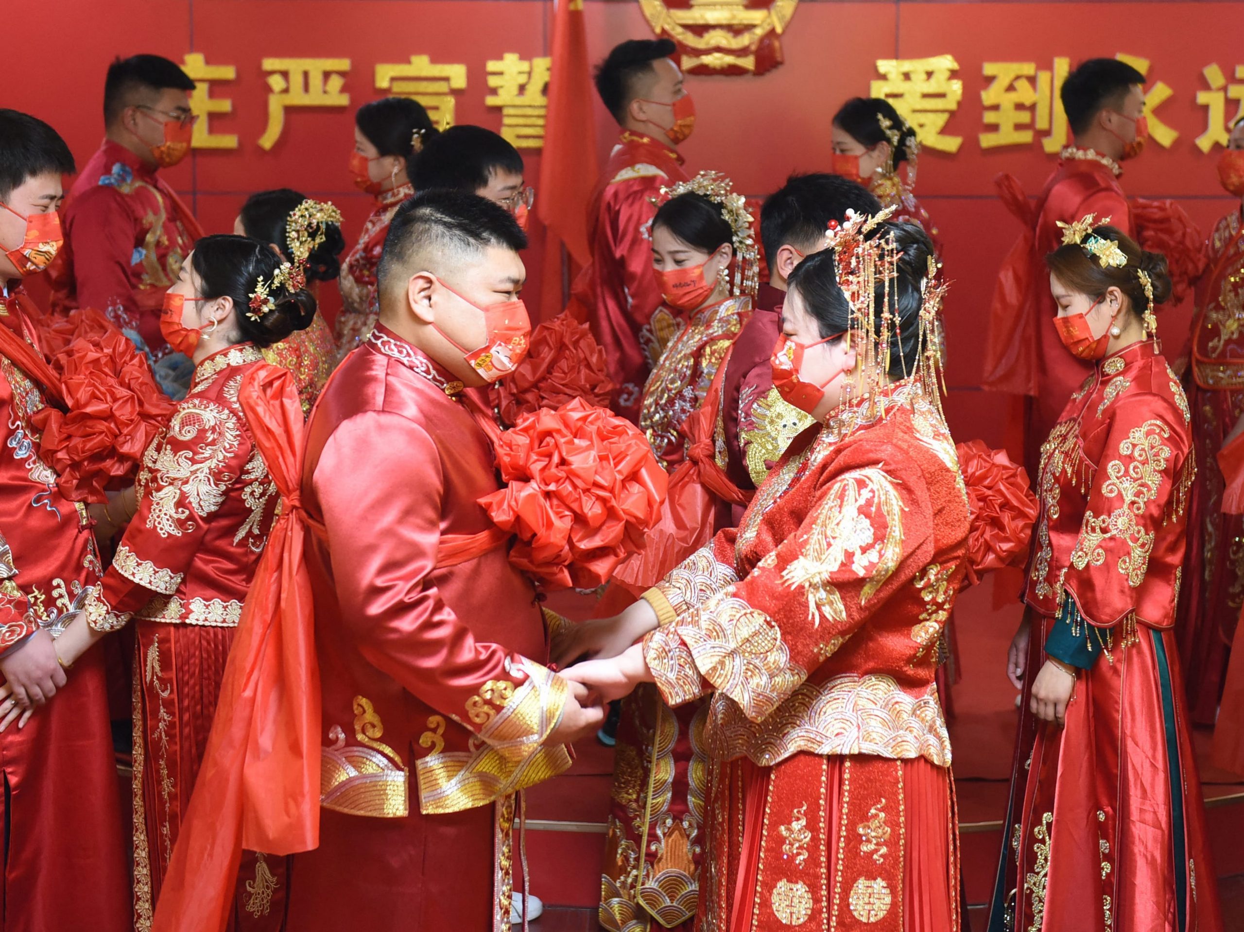 Couples attend a group wedding ceremony at a marriage registry in Donghai in China's eastern Jiangsu province on February 22, 2022, a palindrome day written as "22-2-22".