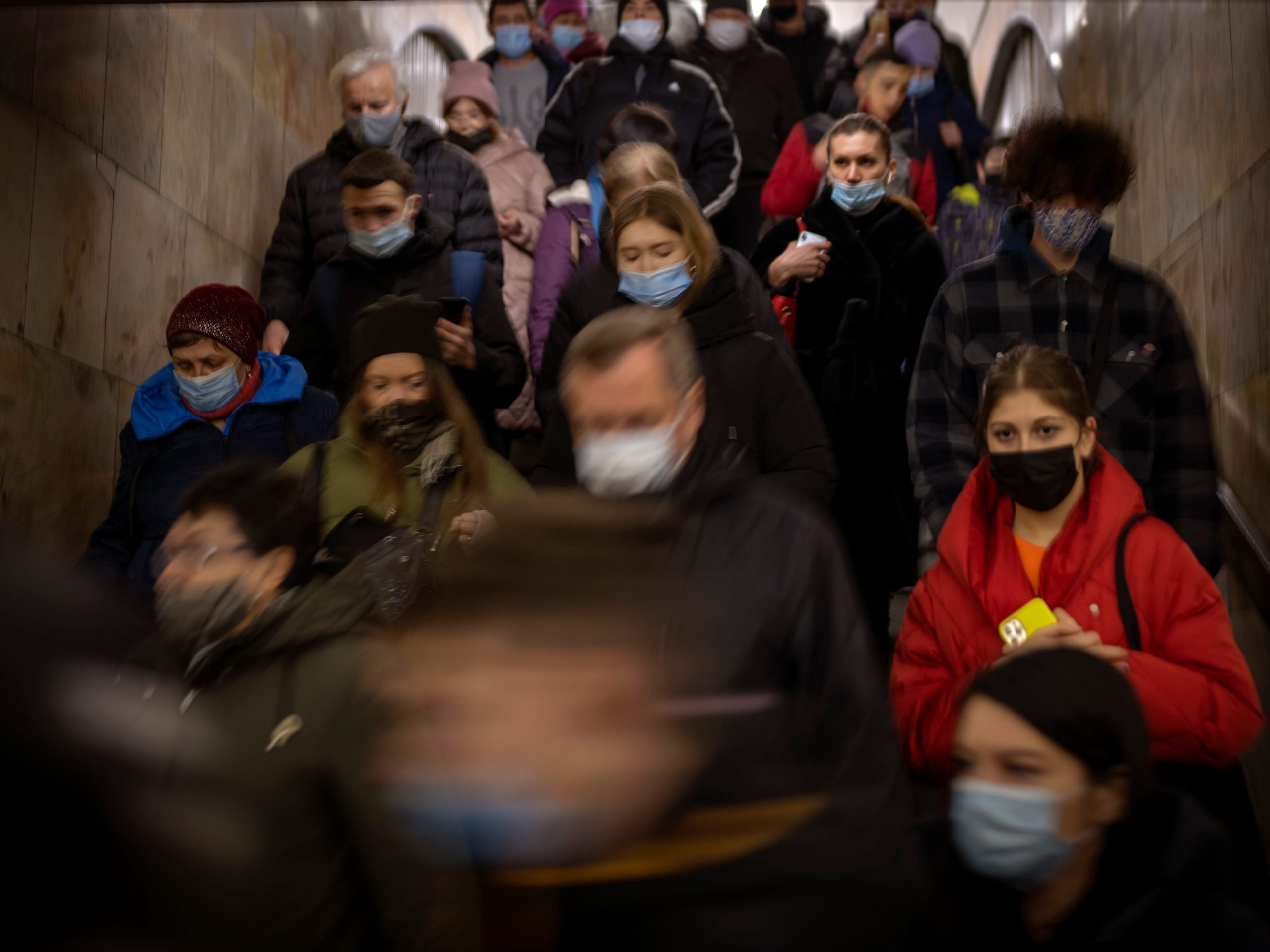 Commuters walk after exiting fa train in Kyiv, Ukraine, Wednesday, Feb. 23, 2022.