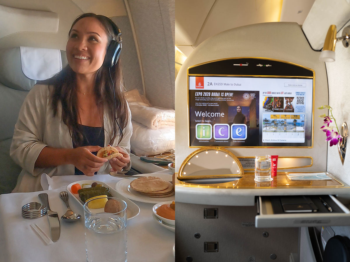 The writer with table of food and entertainment center on first-class flight