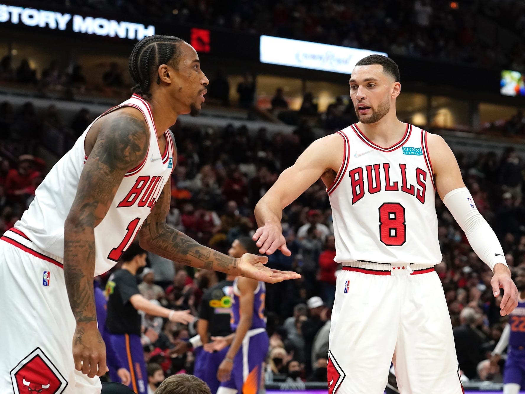 DeMar DeRozan and Zach LaVine high-five during a game in 2022.