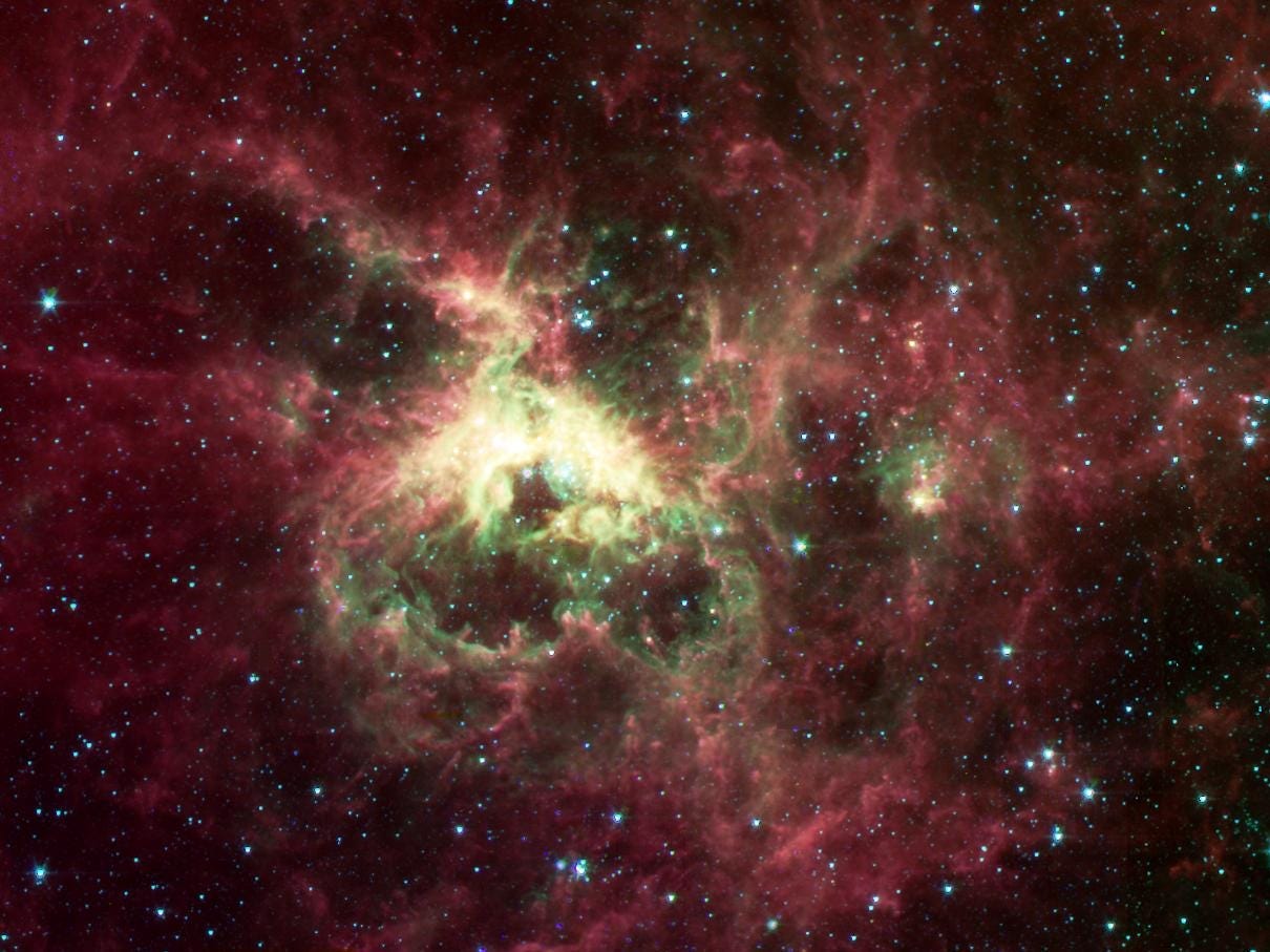 tarantula nebula bright yellow center surrounded by pink wisps of gas in space