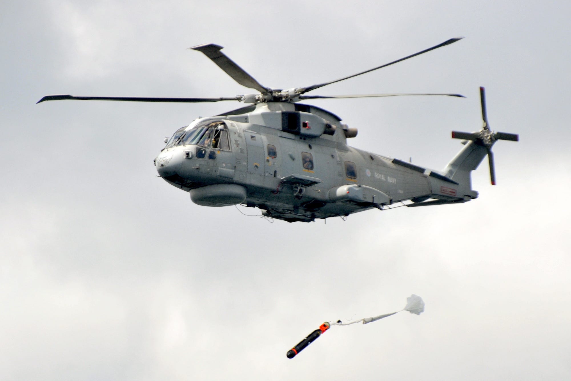 Royal Navy Merlin helicopter launches torpedo