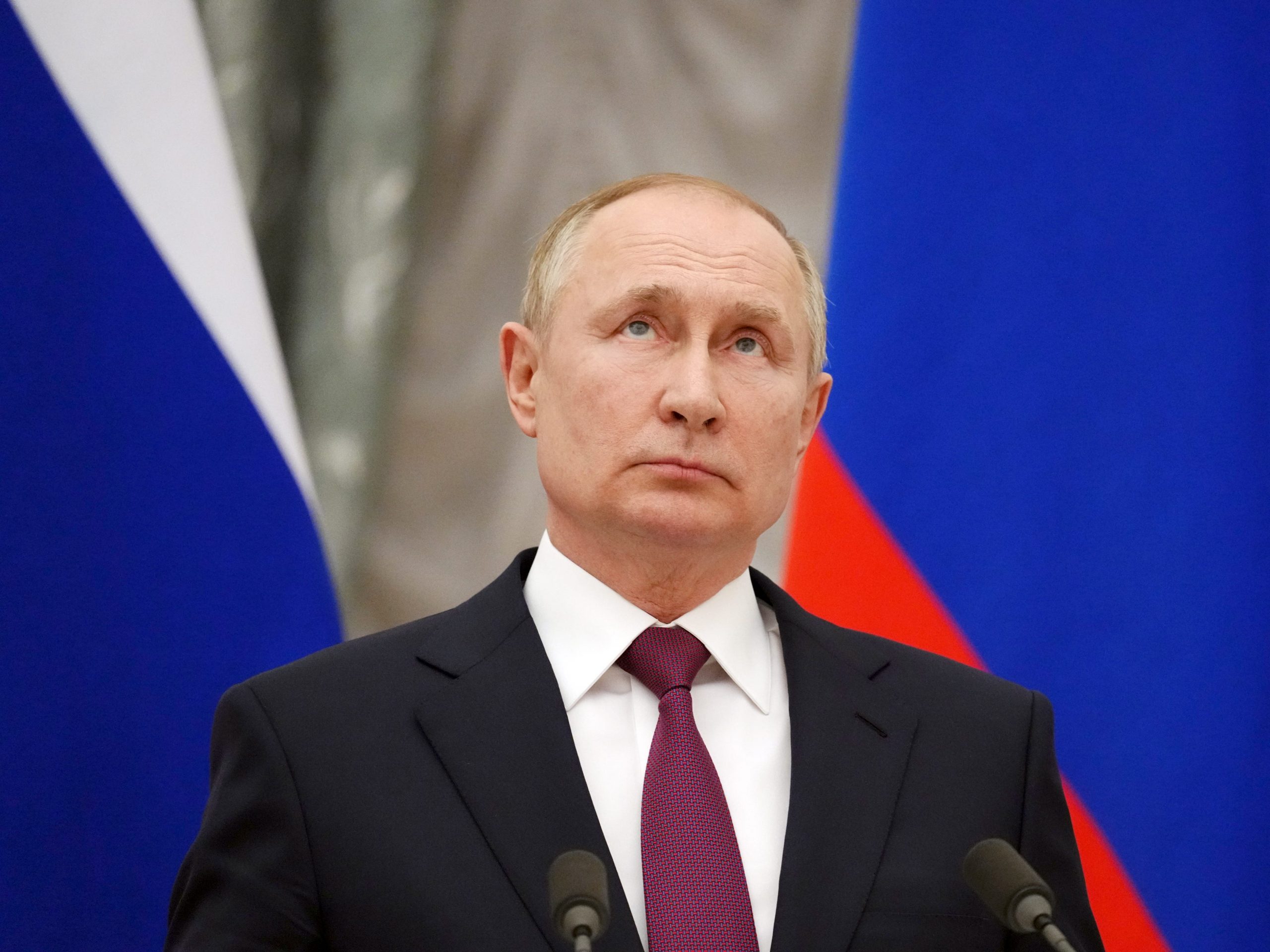 Vladimir Putin stands during a press conference.