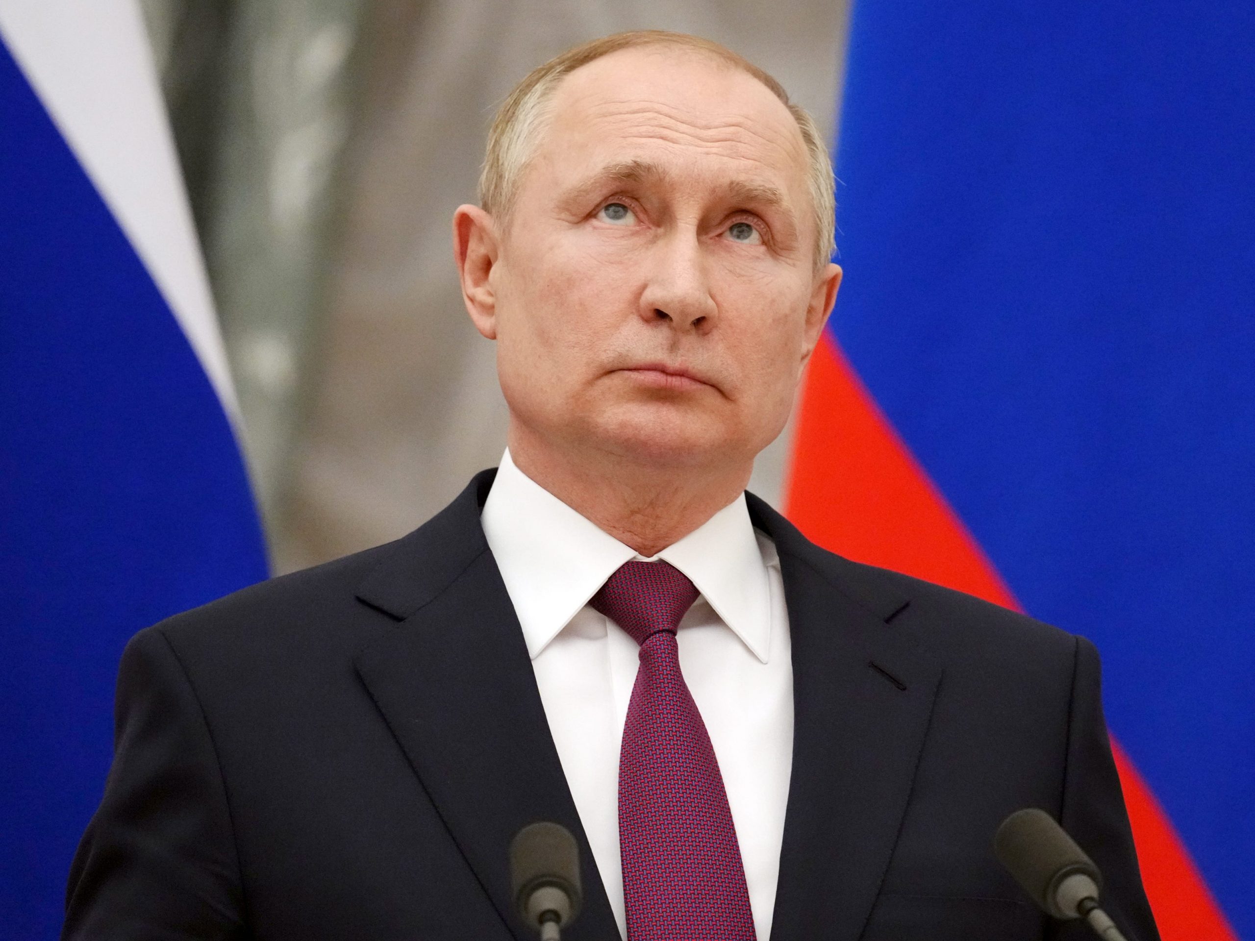 Vladimir Putin stands during a press conference.