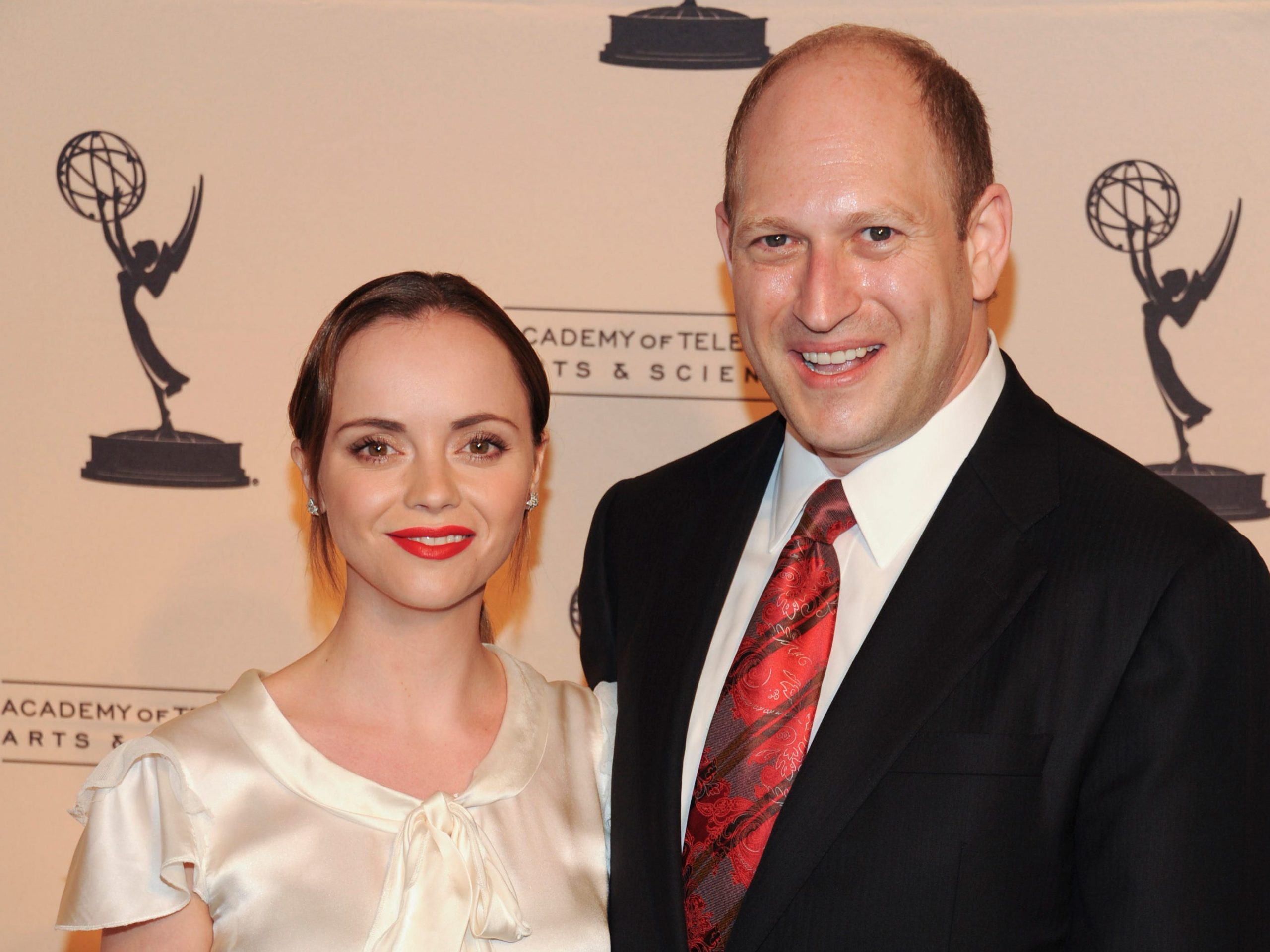 Christina Ricci stands next to RAINN founder Scott Berkowitz at a red carpet event.