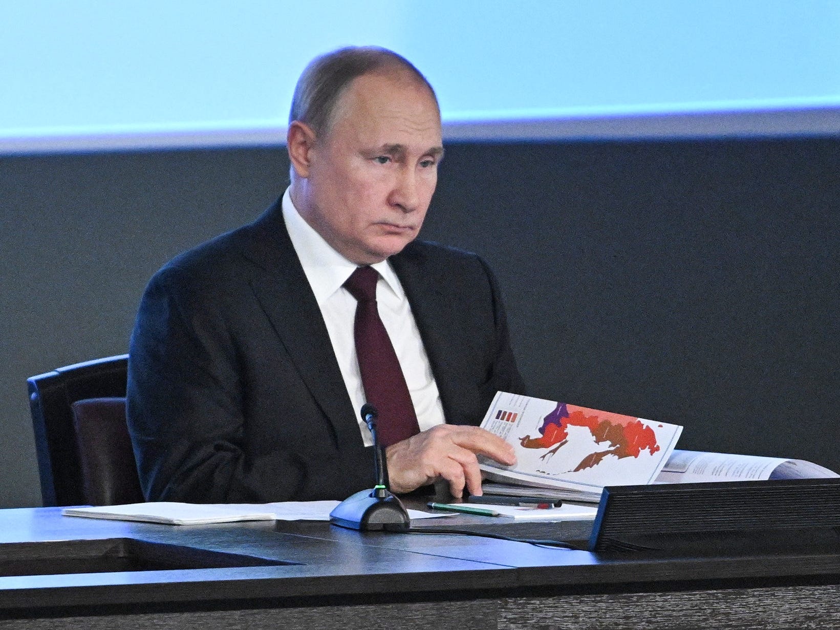 Vladimir Putin sits during a meeting.