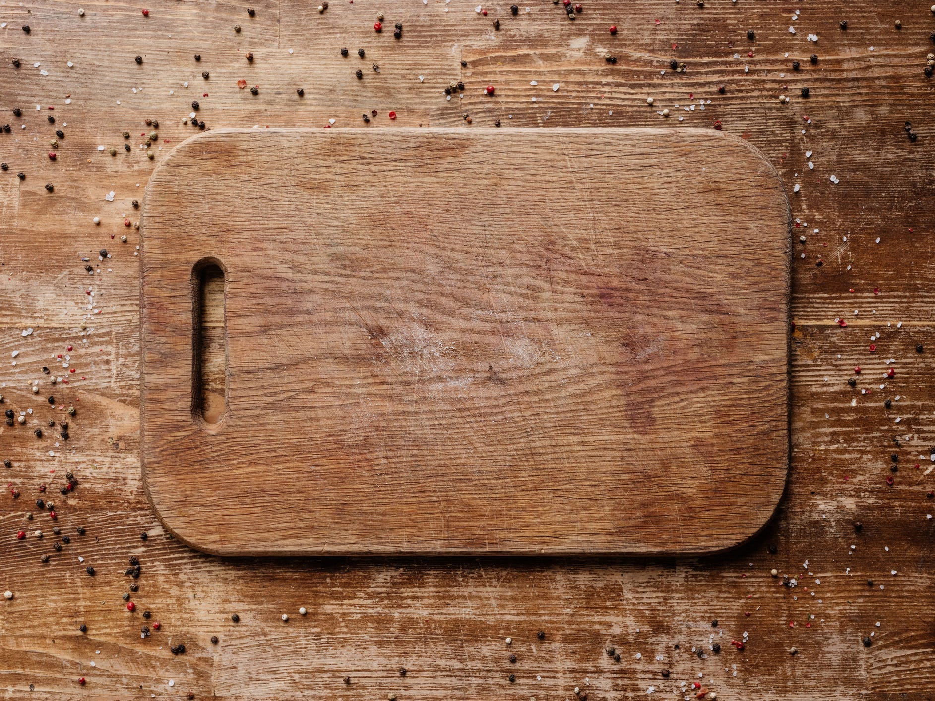 Wooden cutting board on top of a wooden table